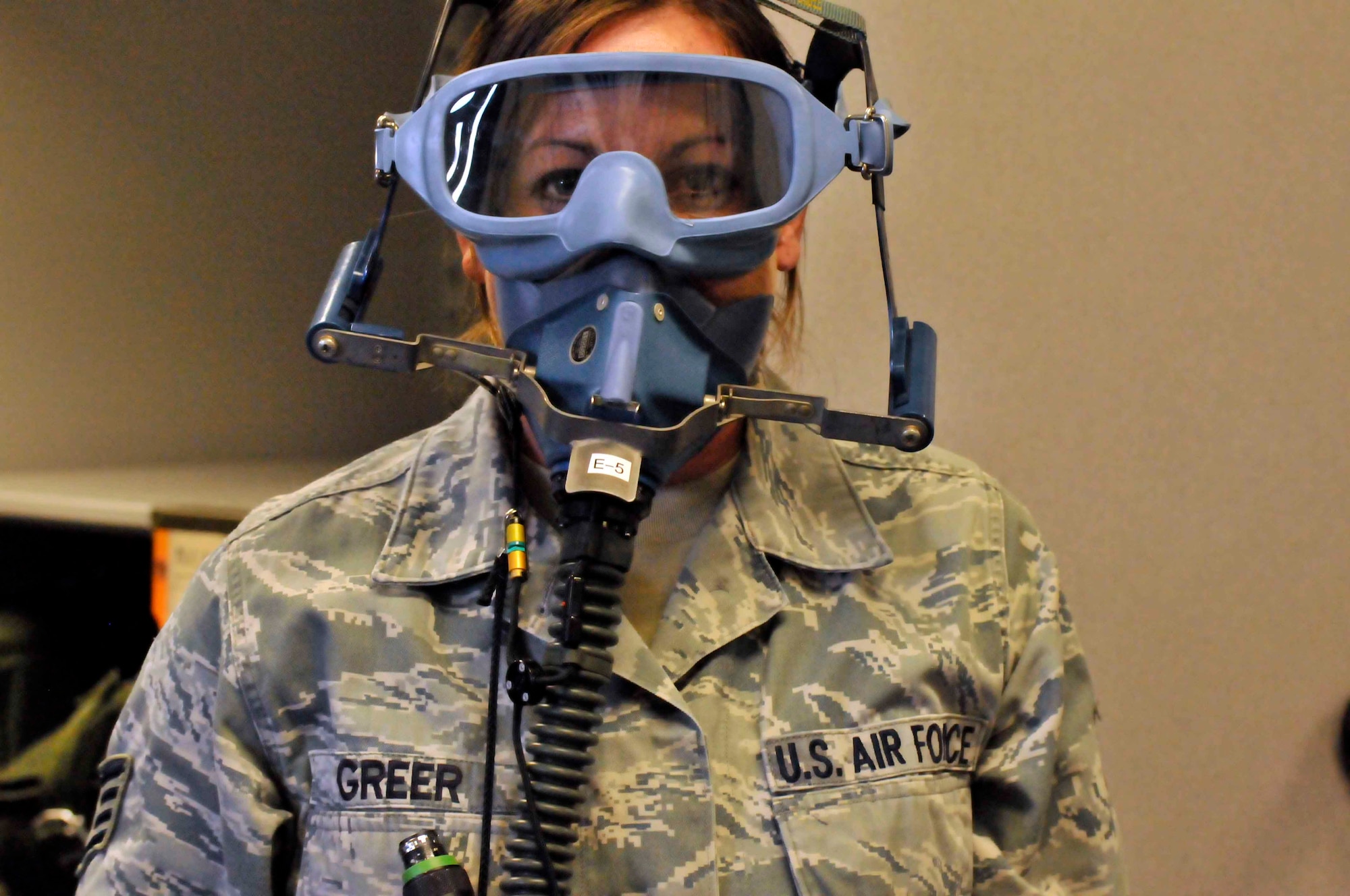PATRICK AIR FORCE BASE, Fla. - Staff Sgt. Stacie Greer, aircrew flght equipment specialist, 920th Operations Support Squadron, puts on a smoke mask to test it following an aircrews' performance during the Cocoa Beach Air Show Nov. 4-5. AFE specialists are required to test and check all life support equipment before and after each flight. (U.S. Air Force Photo/Capt. Ryan Liss)