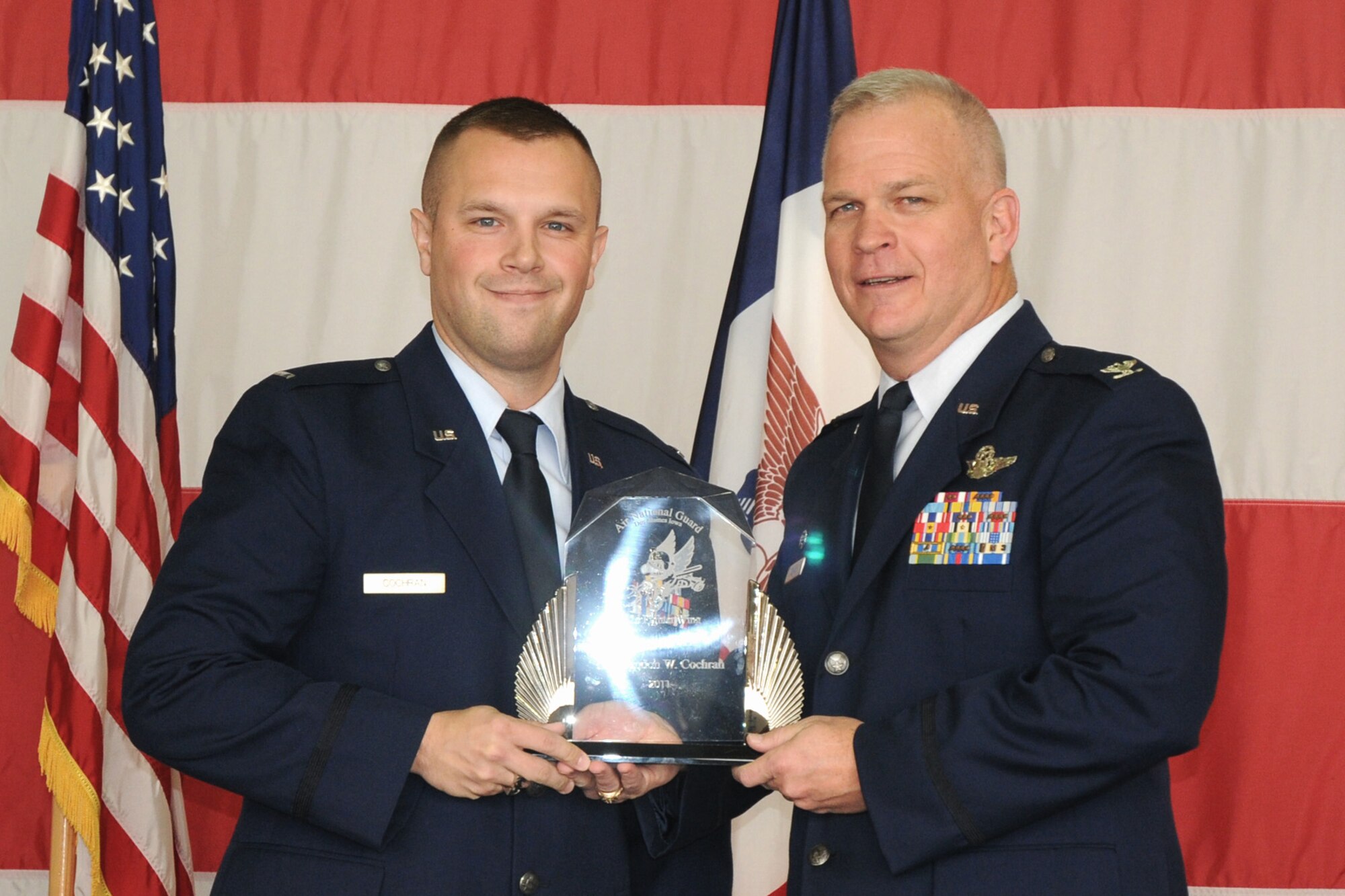 Col. Drew DeHaes (right) presents 1st Lt. Brandon Cochran (left) with the Officer of the Year award during the 2011 Awards Ceremony held in the hangar of the 132nd Fighter Wing, Des Moines, Iowa on November 6, 2011.  (US Air Force photo/Staff Sgt. Linda E. Kephart)(Released)