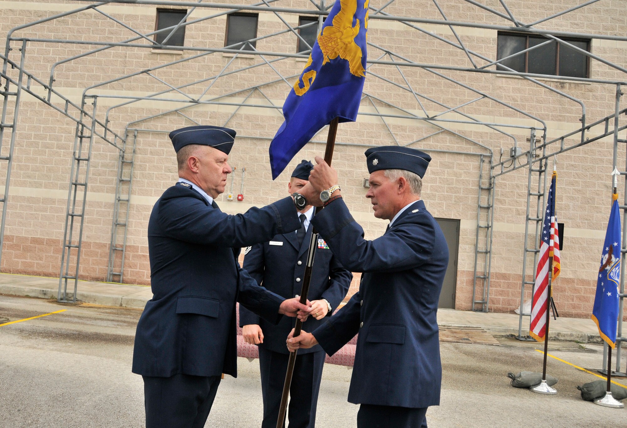 Lt. Col. Elwin Rozyskie passes the guidon to Lt. Col. George Adrian, who assumed command of the 482nd Fighter Wing Logistics Readniess Squadron during an assumpion of command ceremony held at Homestead Air Reserve Base, Fla., Nov. 6. (U.S. Air Force photo by Senior Airman Katie Spencer, 482nd FW Public Affairs) 
