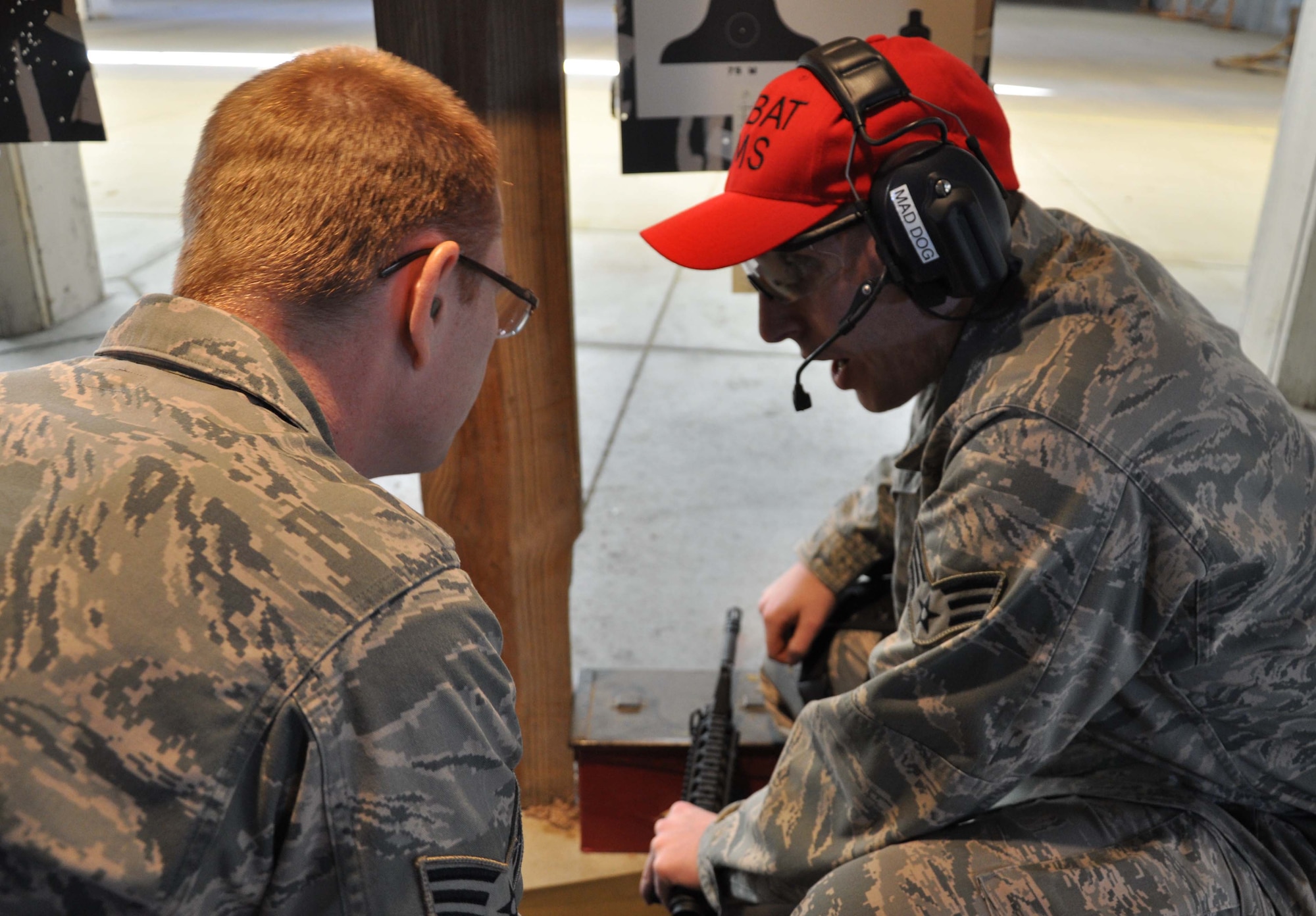 Senior Airman Joseph Aaron, 931st Security Forces Squadron, McConnell Air Force Base, Kan., instructs Staff Sgt. Steve Brown, 931st Civil Engineer Squadron, on weapons sighting at the base combat arms training and maintenance facilty, Nov. 6, 2011.  The Airmen of the 931st CES were conducting their annual weapons qualification training firing the M4 carbine rifle.  (U.S. Air Force photo by 1st Lt. Zach Anderson)