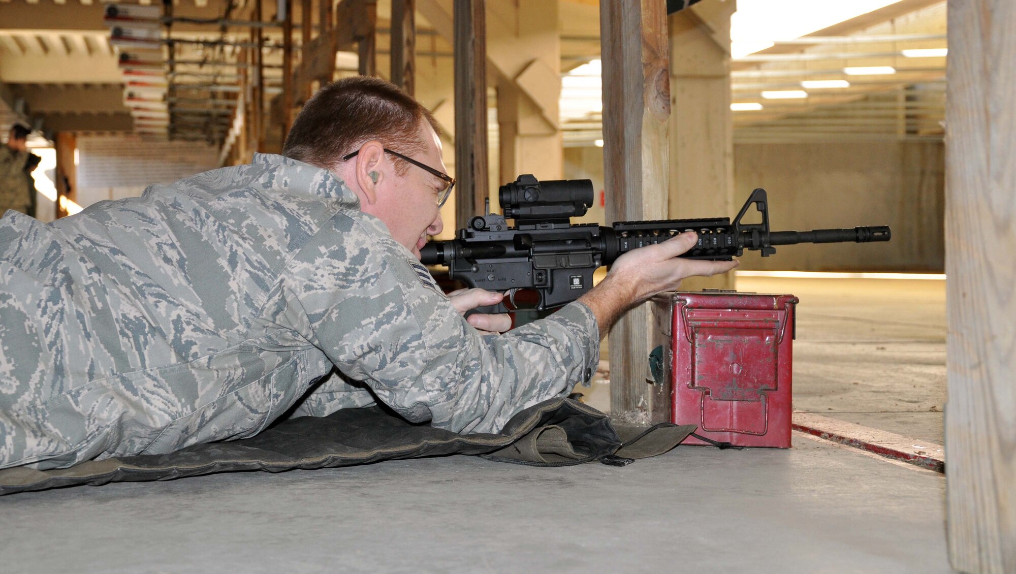 Senior Airman Mike Goode, 931st Civil Engineer Squadron, McConnell Air Force Base, Kan., fires an M4 carbine rifles while at the base combat arms training and maintenance facilty, Nov. 6, 2011.  The Airmen of the 931st CES were conducting their annual weapons qualification training.  (U.S. Air Force photo by 1st Lt. Zach Anderson)