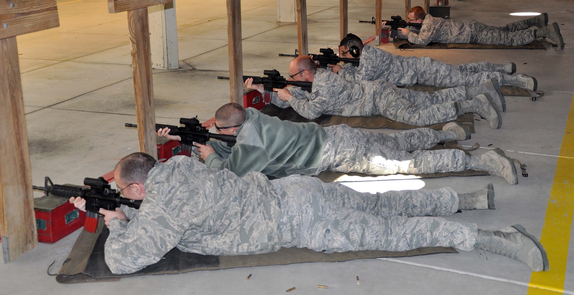 Members of the 931st Civil Engineer Squadron, McConnell Air Force Base, Kan., fire M4 carbine rifles while at the base combat arms training and maintenance facilty, Nov. 6, 2011.  The Airmen of the 931st CES were conducting their required annual weapons qualification training over the UTA weekend.  (U.S. Air Force photo by 1st Lt. Zach Anderson)