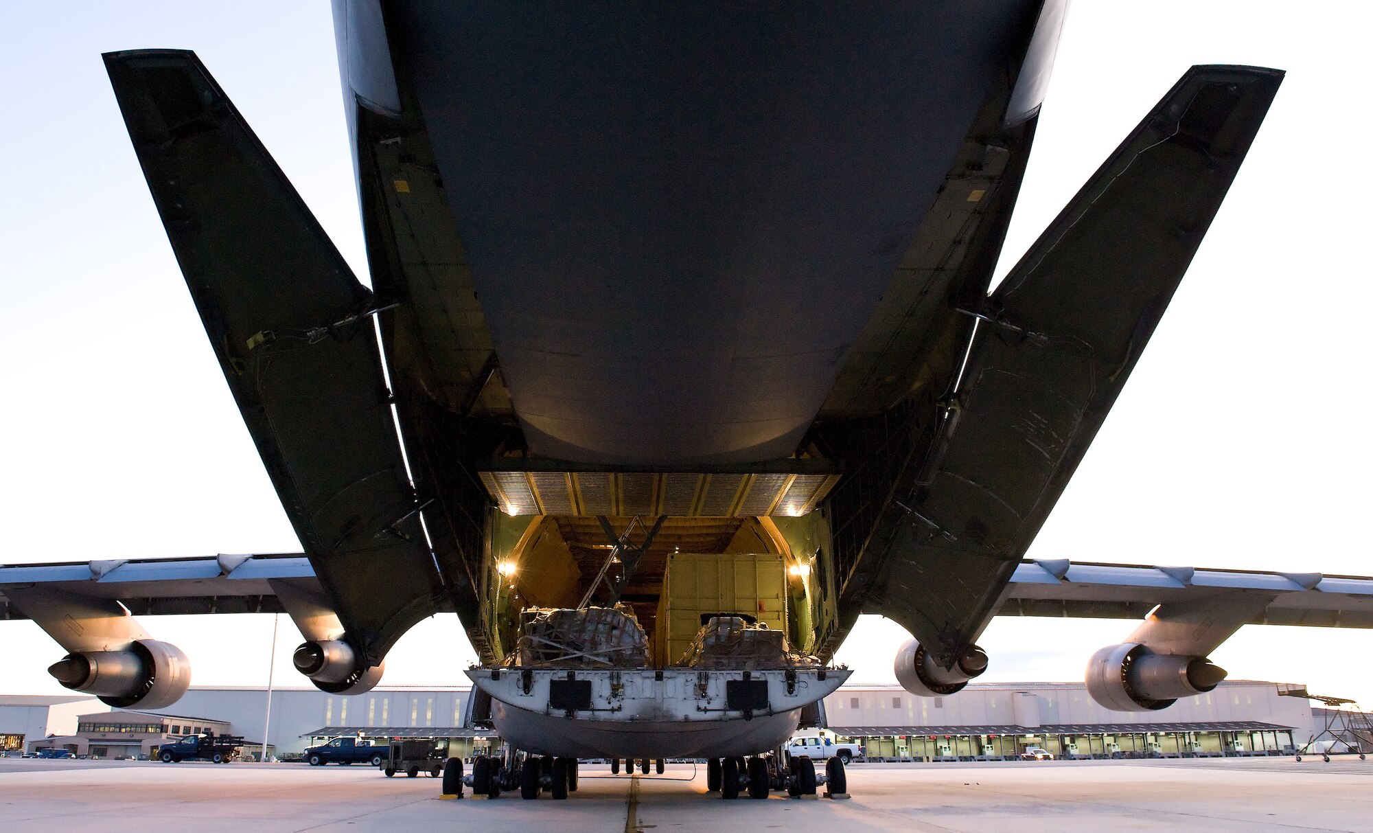 Team Dover aircrew members and ground personnel load cargo and preflight a C-5 at Dover Air Force Base, Del., Oct. 20, 2011. The aircraft hauled cargo to Iraq and was part of the Air Mobility Command surge, which tested the ability of the C-5 fleet to transport large numbers of supplies, equipment and personnel around the globe in October. (U.S. Air Force photo by Roland Balik)