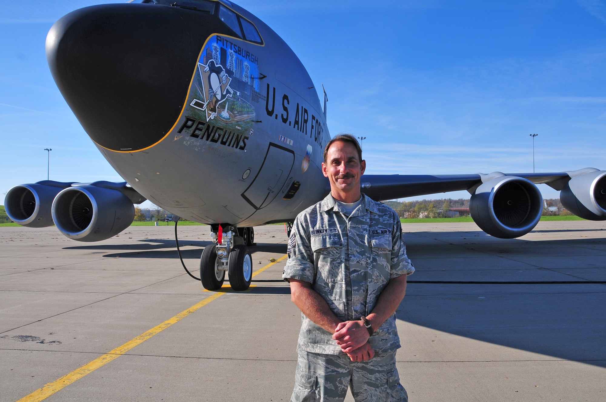 Members of the Pittsburgh Penguins hockey team autograph one of the 171st Air Refueling Wing's KC135 stratotankers which displays nose art honoring the team November 2. (National Guard photo by Master Sgt. Ann Young/Released)