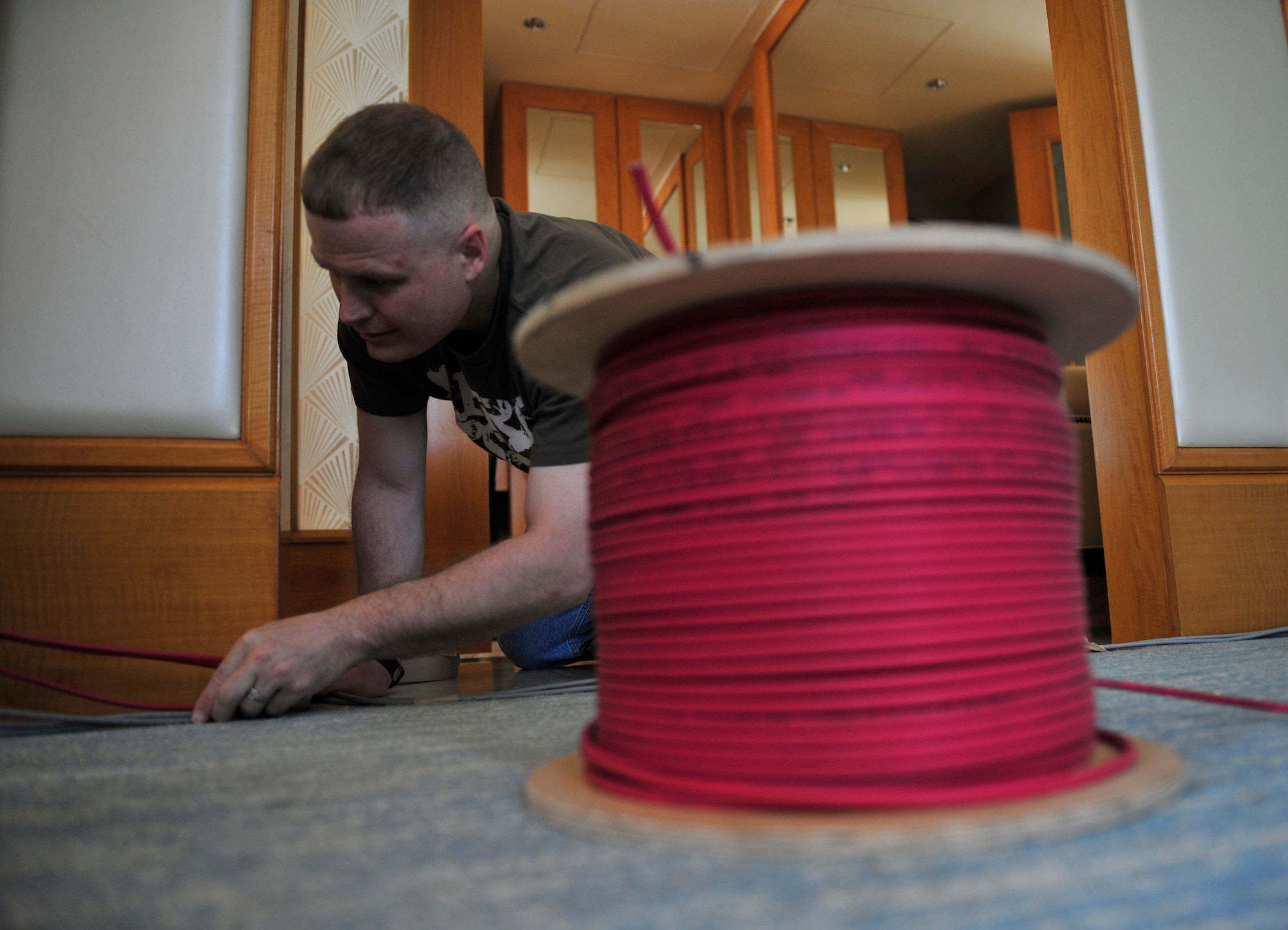 Senior Master Sgt. Troy Baird, from the 380th Expeditionary Communications Squadron, installs military network cables in the main operations center for the 2011 Dubai Airshow.  Baird is part of an 11-member communications team from U.S. Air Forces Central Command that was sent to Dubai to stand-up three operations centers for the bi-annual event.  The operations centers will give U.S. military personnel access to military communications networks so they can check work email and reach back to their home units along with morale computers so they can stay in touch with friends and family members. The Airshow will highlight a variety of U.S. Air Force, Navy and Army aircraft showcasing the range of U.S. military airpower capabilities. Aircrew and support personnel from bases in the gulf region, Europe and the U.S. are participating in the event, which is expected to draw more than 55,000 visitors.  (U.S. Air Force Photo/Tech. Sgt. Patrick Mitchell)