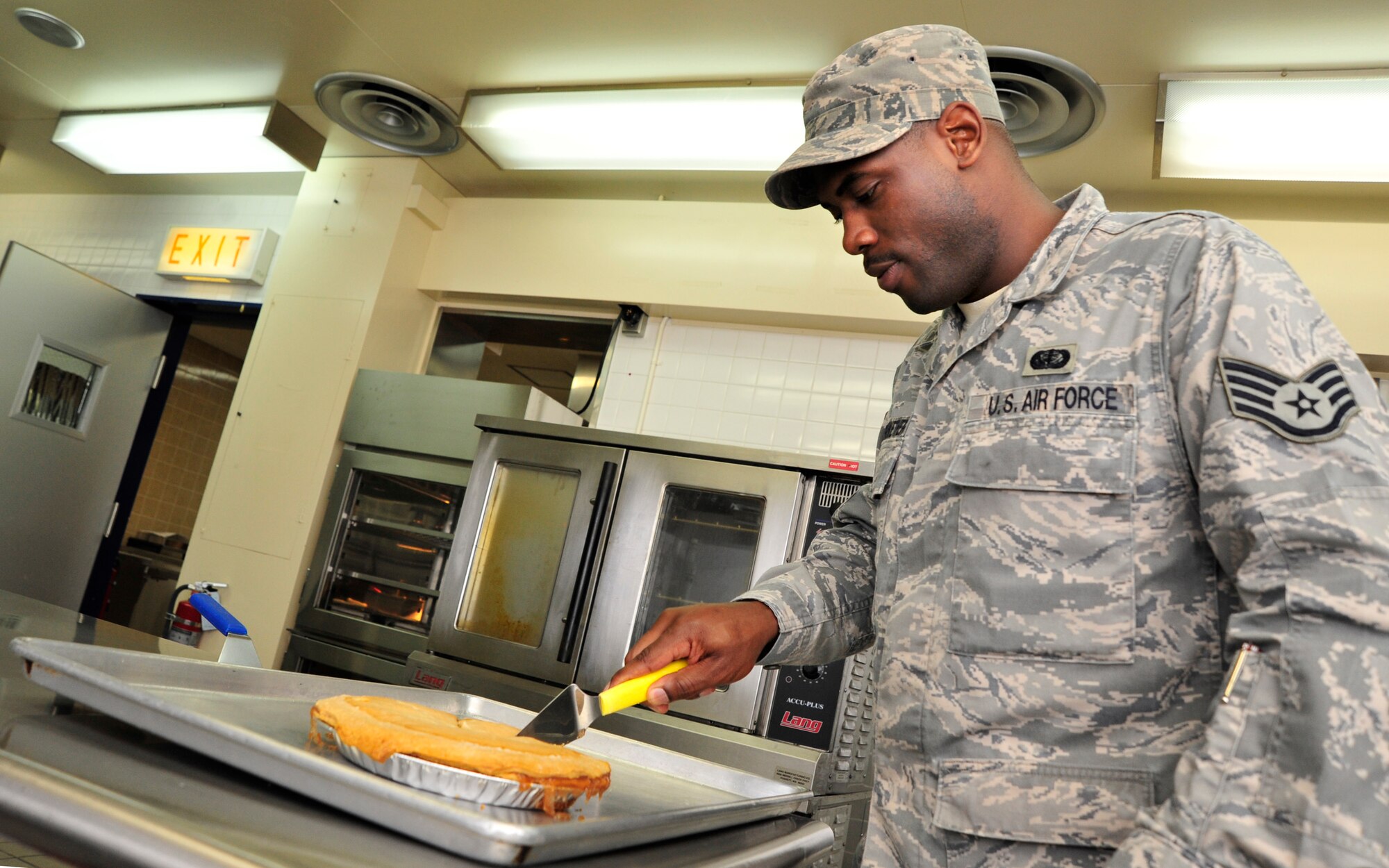 MISAWA AIR BASE, Japan – U.S. Air Force Staff Sgt. Reid Merriwether, 35th Force Support Squadron food service technician, slices an apple pie for hungry exercise participants at the Falcon Feeder dining facility during an operational readiness exercise here Nov. 6. The 35th Fighter Wing is currently going through an ORE in preparation for an operational readiness inspection in December. (U.S. Air Force photo/Staff Sgt. Nathan Lipscomb)