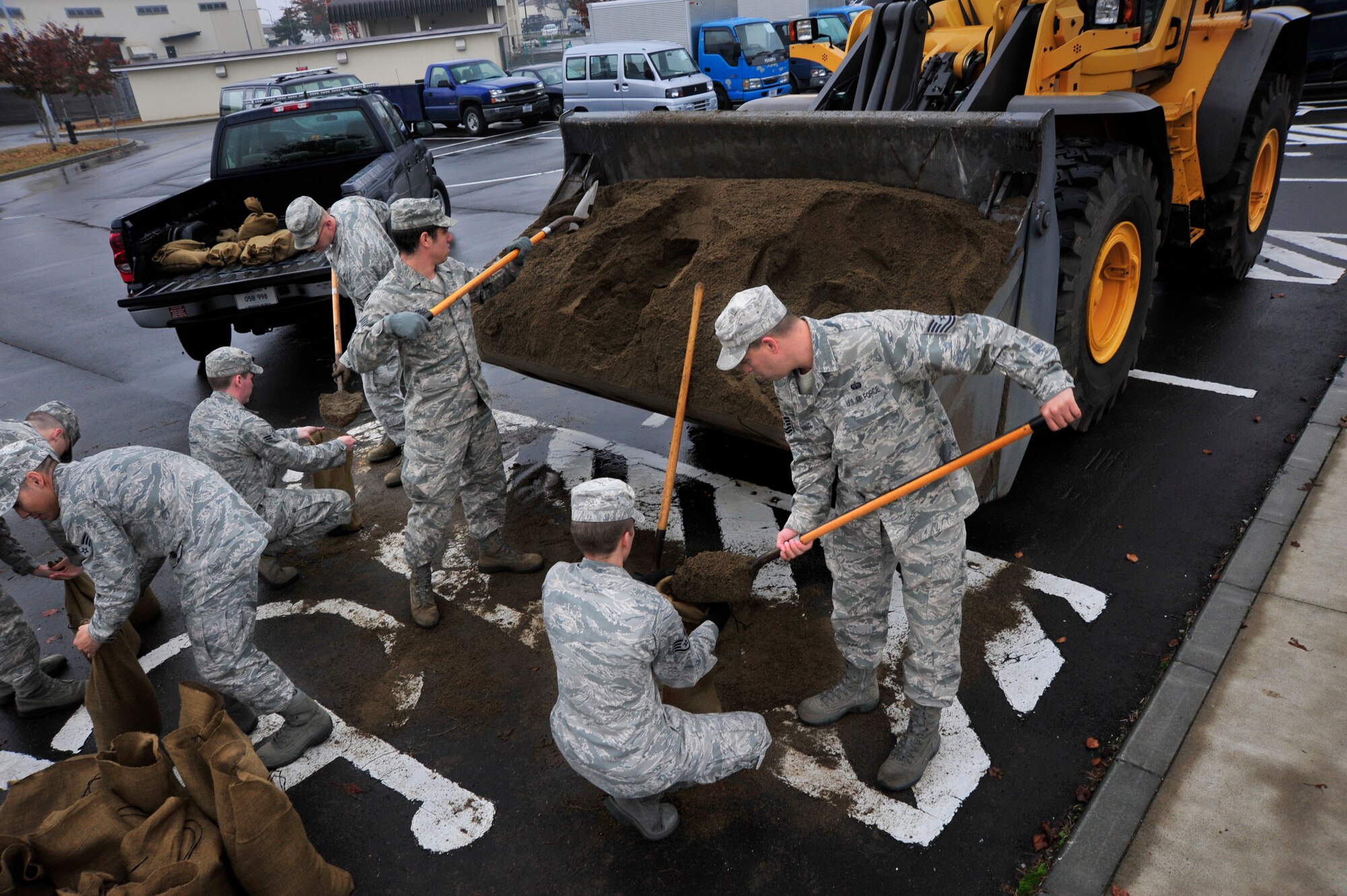 MISAWA AIR BASE, Japan – Members of the 35th Communications Squadron fill sand bags during an operational readiness exercise here Nov. 6. They are filling sandbags in order to protect buildings in case of simulated attack. The 35th Fighter Wing is currently going through an ORE in preparation for an operational readiness inspection in December. (U.S. Air Force photo/Staff Sgt. Nathan Lipscomb)