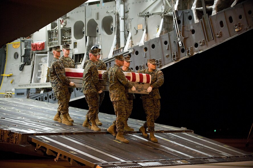 A U.S. Marine Corps carry team transfers the remains of Marine Lance Cpl. Nickolas A. Daniels, of Elmwood Park, Ill., at Dover Air Force Base, Del., Nov. 7, 2011. Daniels was assigned to the 3rd Combat Engineer Battalion, 1st Marine Division, I Marine Expeditionary Force, Twentynine Palms, Calif. (U.S. Air Force photo/Steve Kotecki)