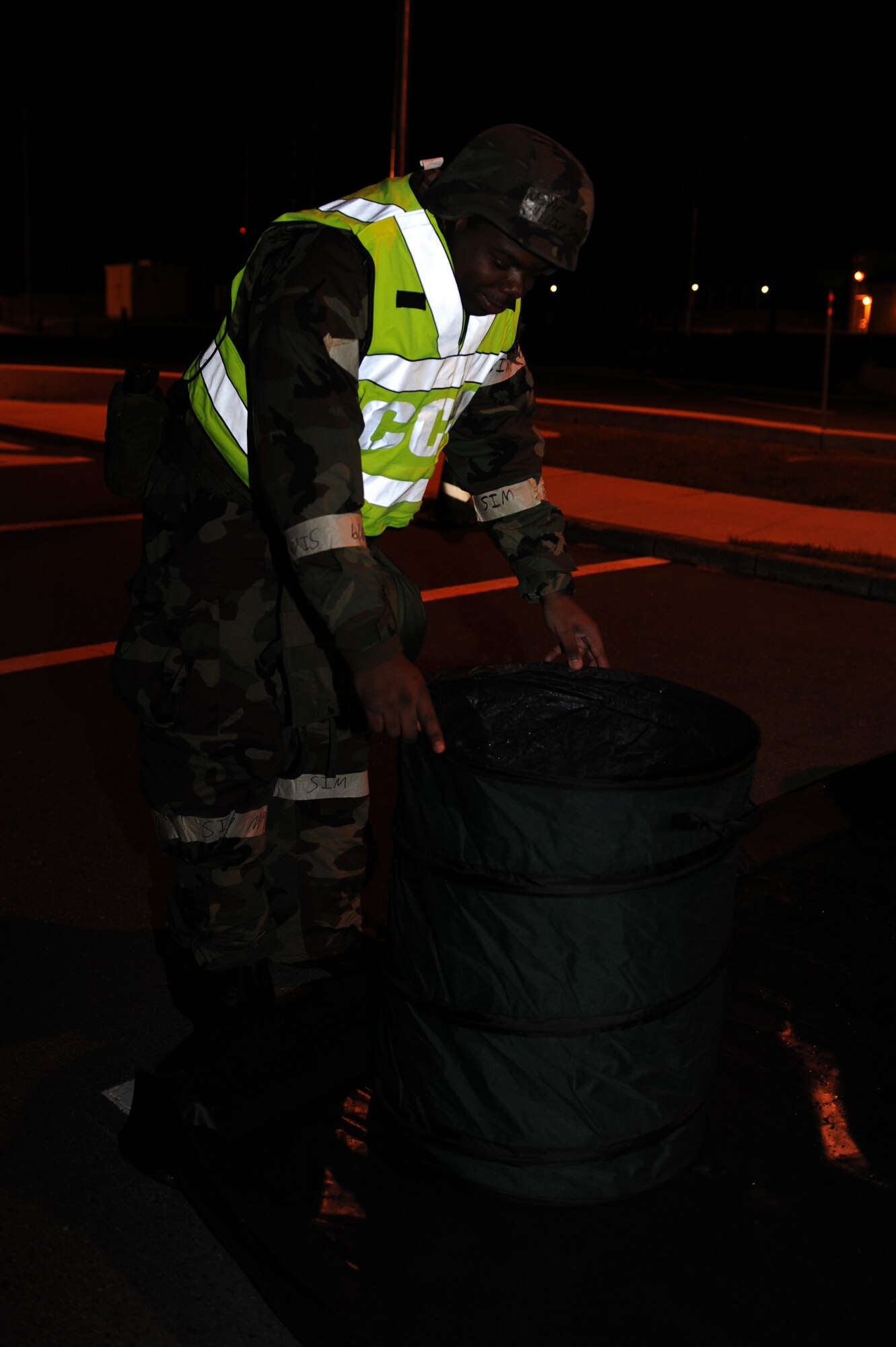 MISAWA AIR BASE, Japan – Senior Airman Phillip Sneed, 35th Medical Support Squadron, places a decontamination bin at a contamination control area during an operational readiness exercise here Nov. 8. The 35th Fighter Wing is preparing for an operational readiness inspection in December. (U.S. Air Force photo by Airman 1st Class Kia Atkins)