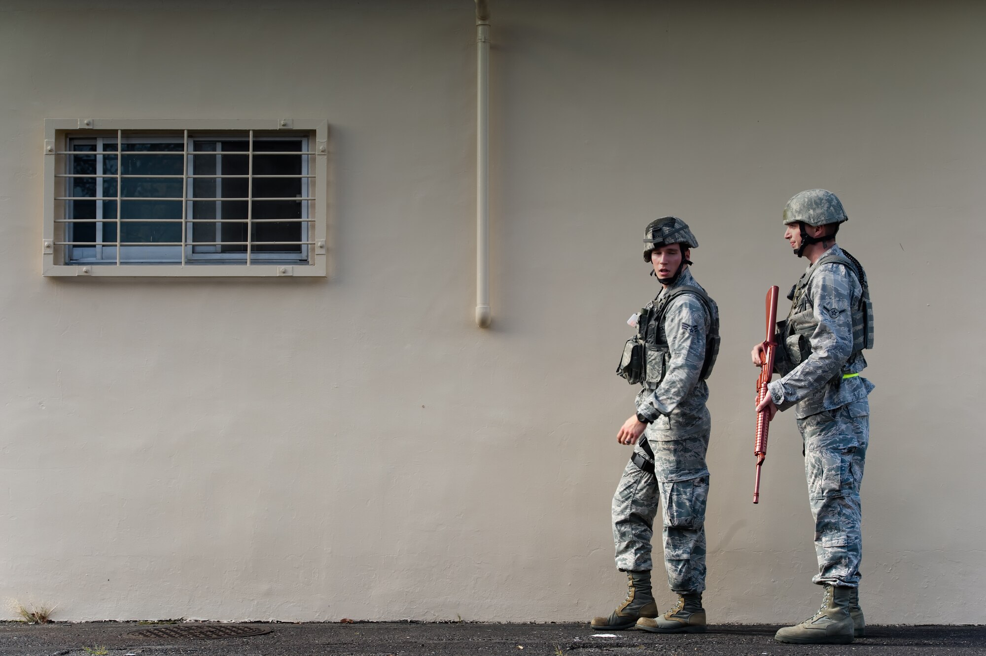 YOKOTA AIR BASE, Japan -- (Left to right) Senior Airman James Butts and Airman Bryce Eddington, patrolmen from the 374th Security Forces Squadron, search an unclear area during an active shooter scenario at Yokota Air Base, Japan, Nov. 7, 2011. Yokota is participating in a week-long exercise to maintain operational readiness cabilities. (U.S. Air Force photo/Osakabe Yasuo)