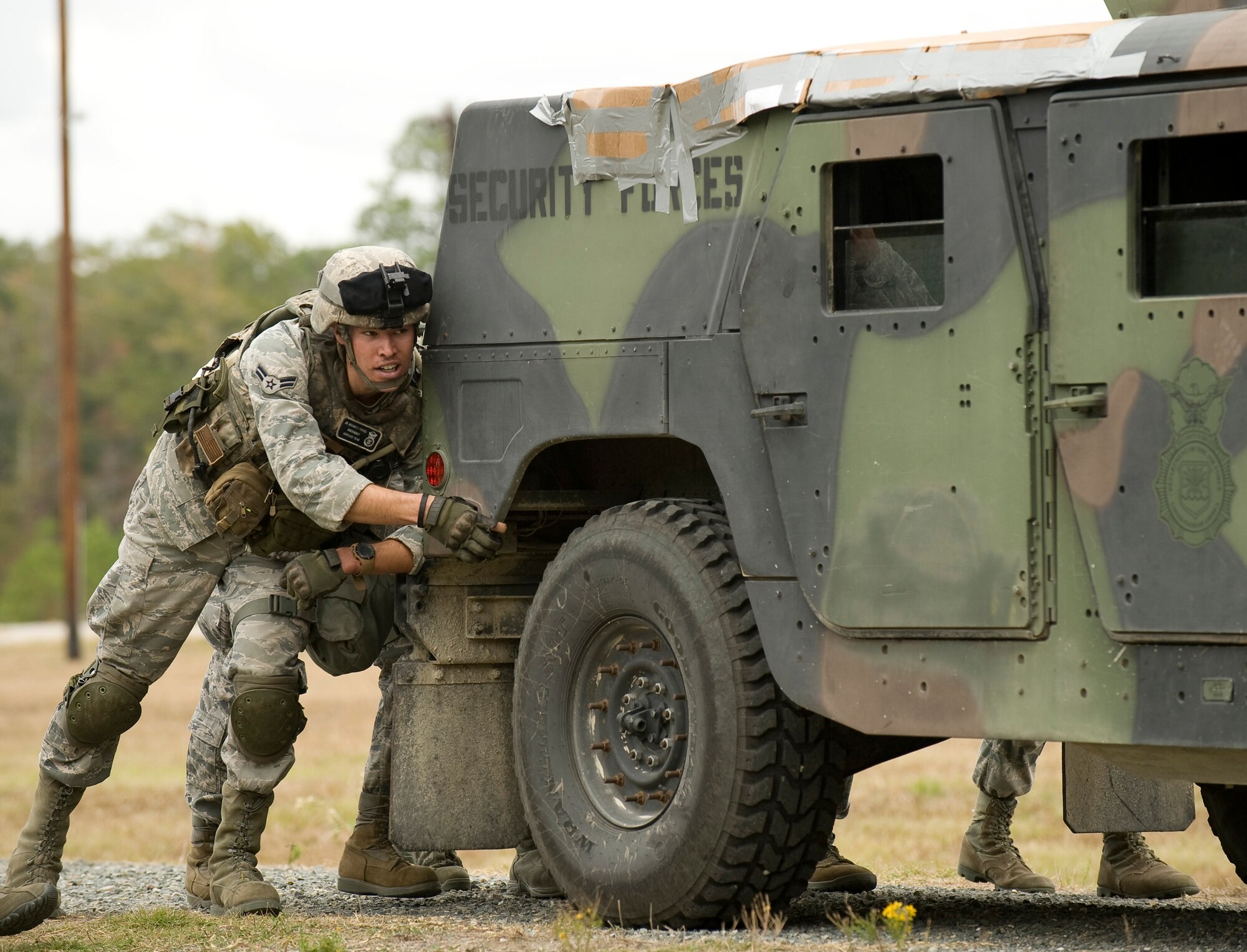 Members of the 2nd Security Forces Squadron push a High-Mobility Multipurpose Wheeled Vehicle, better known as a Humvee, during the mental and physical challenge portion of the 2011 Air Force Global Strike Challenge on Camp Minden, La., Nov. 7. The purpose of Global Strike Challenge is to build a culture of excellence and esprit de corps as we recognize the 'best of the best' in the command. (U.S. Air Force photo/Senior Airman Chad Warren)(RELEASED)