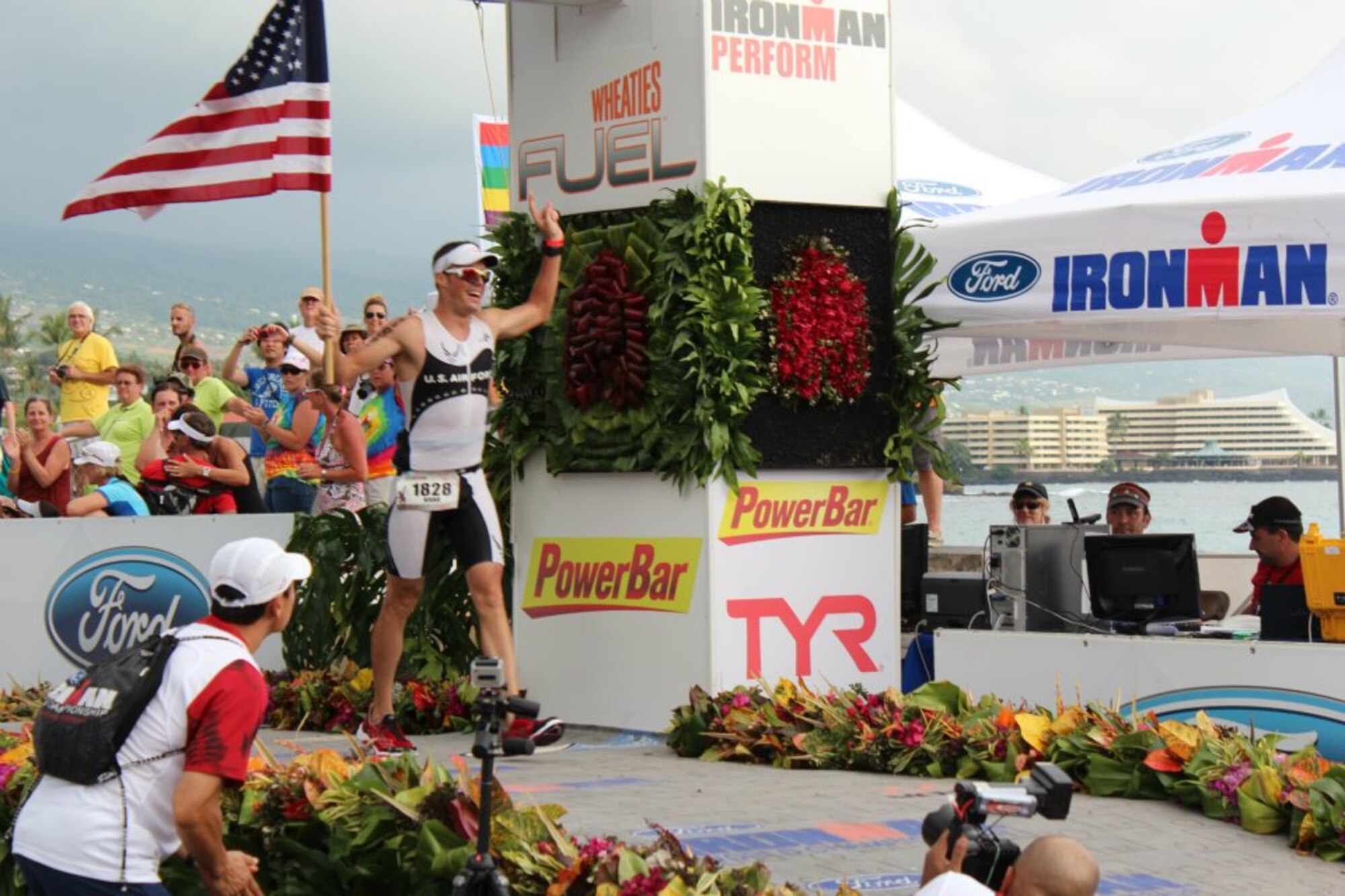 Staff Sgt. Bradley Williams, 51st Maintenance Operations Squadron senior weapons coordinator, crosses the finishline of the 140.4 miles the 2011 Ford IRONMAN Championship in Kailua-Kona, Hawaii Oct. 8, 2011. An IRONMAN challenge consists of a 2.4-mile swim, 112-mile bike race and 26.2-mile run. (Courtesy photo/Jennifer Loos) 