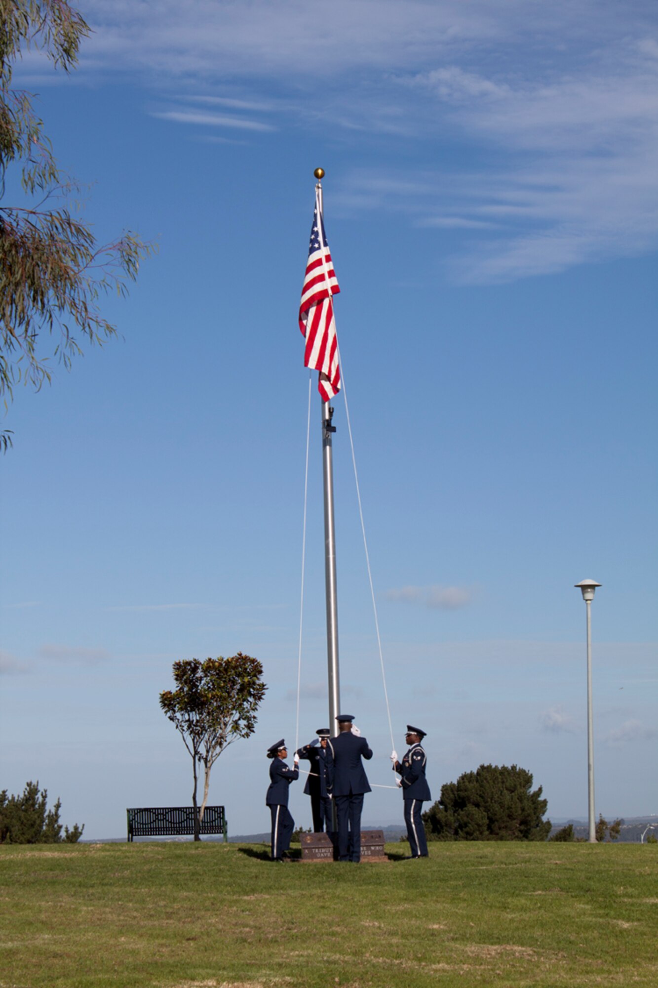 VANDENBERG AIR FORCE BASE, Calif. -- Members of the Vandenberg Honor Guard raise the flag during the Beattie Park flag pole dedication in Lompoc Saturday, Nov. 5, 2011.  The flag pole was dedicated to honor fallen members of past and current wars.  (U.S. Air Force photo/Janet Kays) 

  