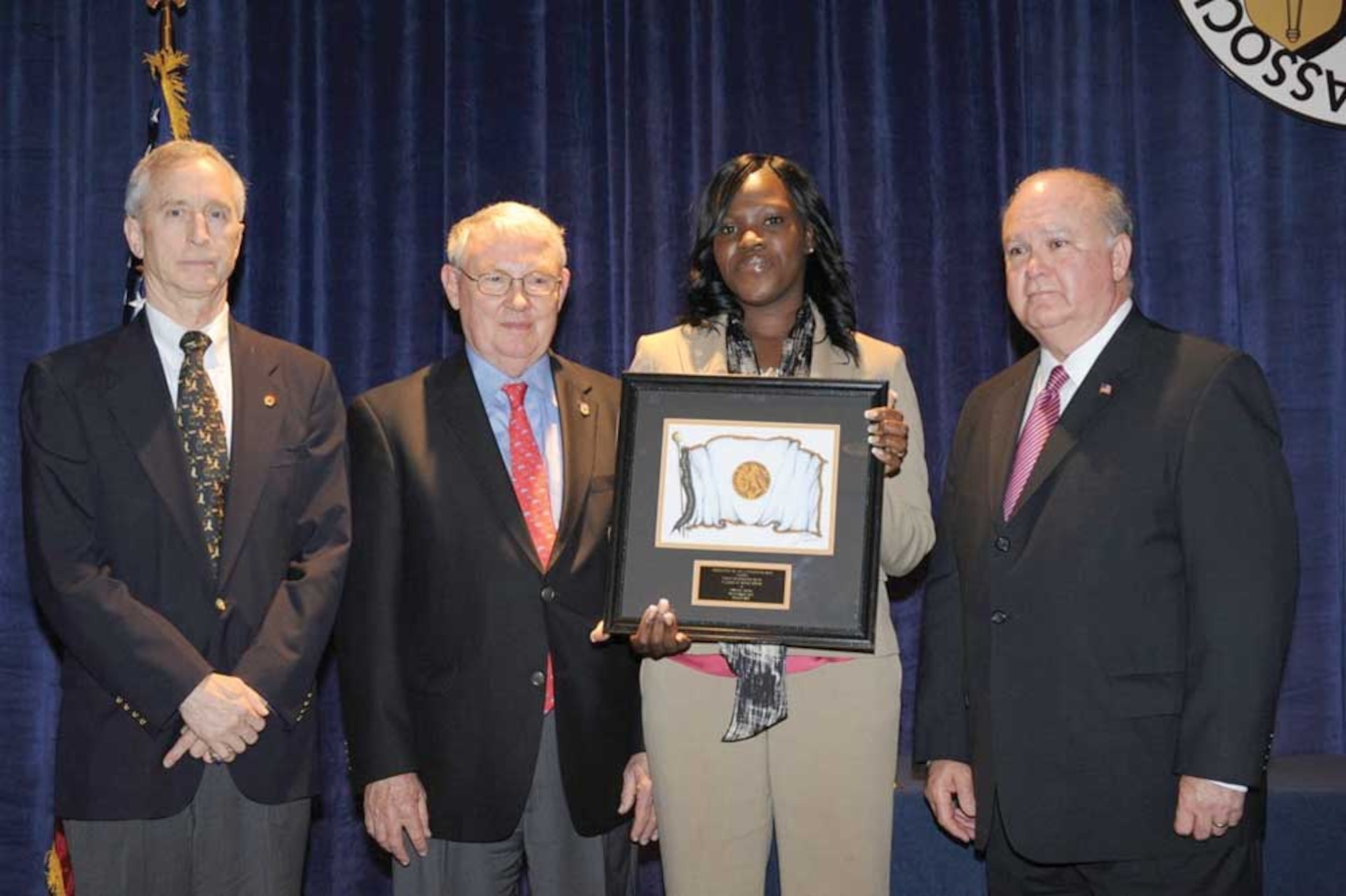 (From left to right:) Larry Bethel, AUSA Alaska State President, Theodore G. Stroup, AUSA Education Vice President, Mrs. Frederica Norman, and Undersecretary of the Army, Dr. Joseph W. Westphal, pose for a photo after Norman was presented a plaque for her service to the Joint Base Elmendorf-Richardson Army Family Action Plan and Army Family Team Building programs. (Courtesy photo)