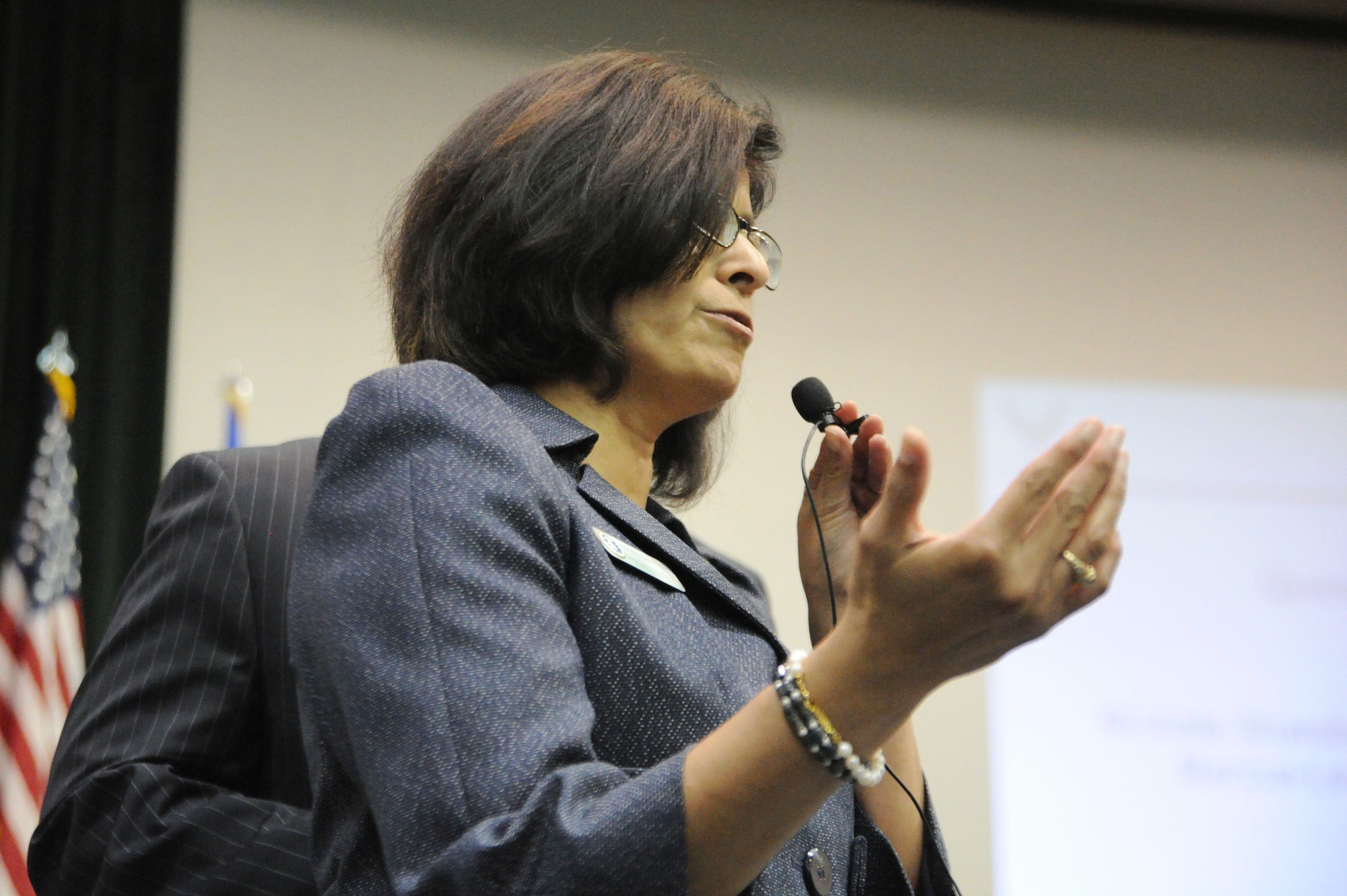 Ermalinda Rodriguez-Heffner, Air Force District of Washington manpower and personnel, gets into the specifics to during the question-and-answer session Nov. 2, 2011 on Joint Base Andrews, Md., at the first of four town hall meetings to discuss Air Force-wide workforce restructuring following the Nov. 2, 2011, Air Force announcement that approximately 4,500 civilian manpower positions must be eliminated in calendar year 2012.