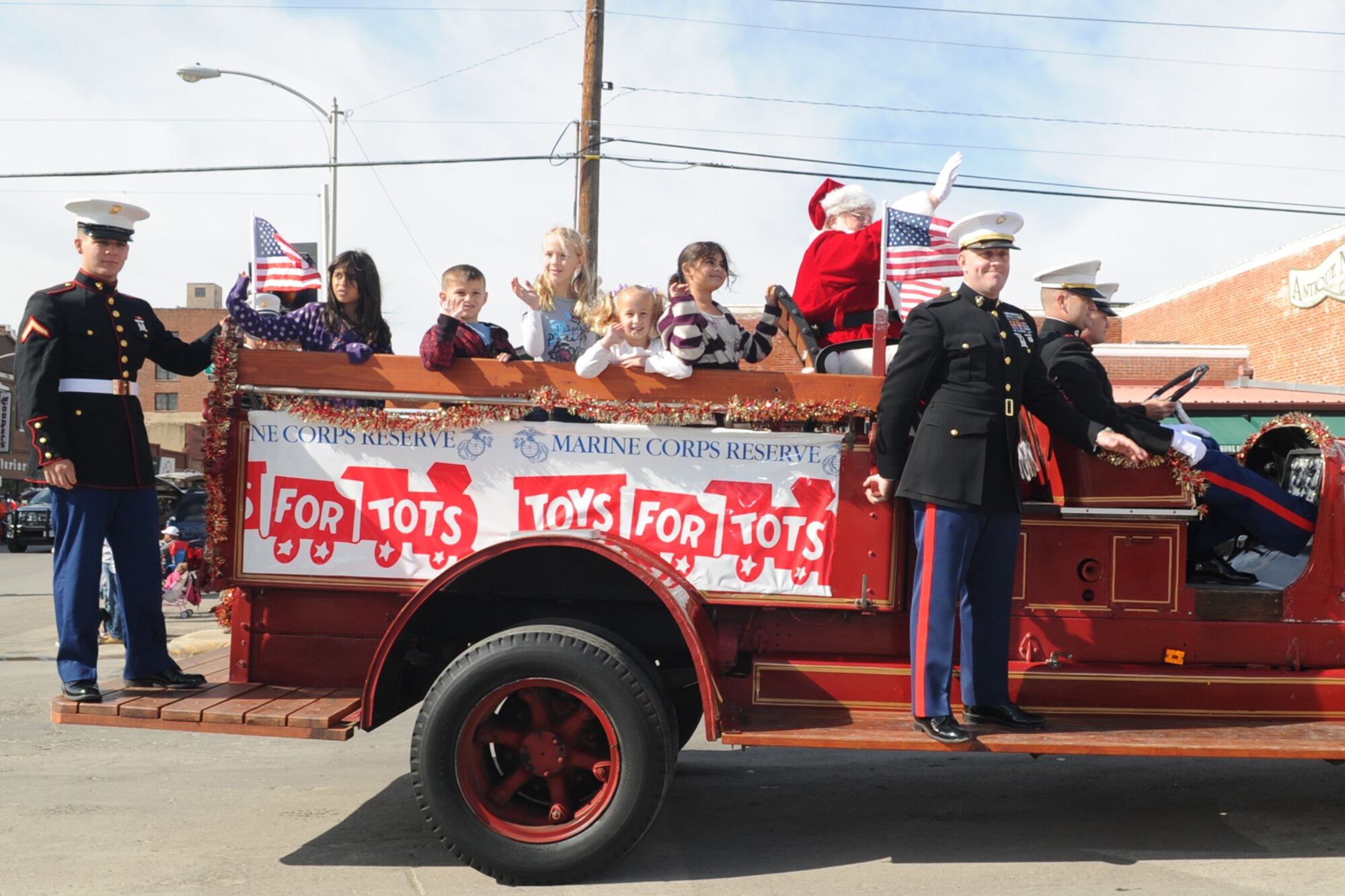 SAN ANGELO, Texas -- Marines from the Marine Corps Detachment at Goodfellow Air Force Base accompany the Toys for Tots wagon during the San Angelo Veterans Day Parade Nov. 5. Marines conduct an annual Toys for Tots program which collects new, unwrapped toys each year and distributes them as Christmas gifts to needy children in the community. (U.S. Air Force photo/Staff Sgt. Laura R. McFarlane)