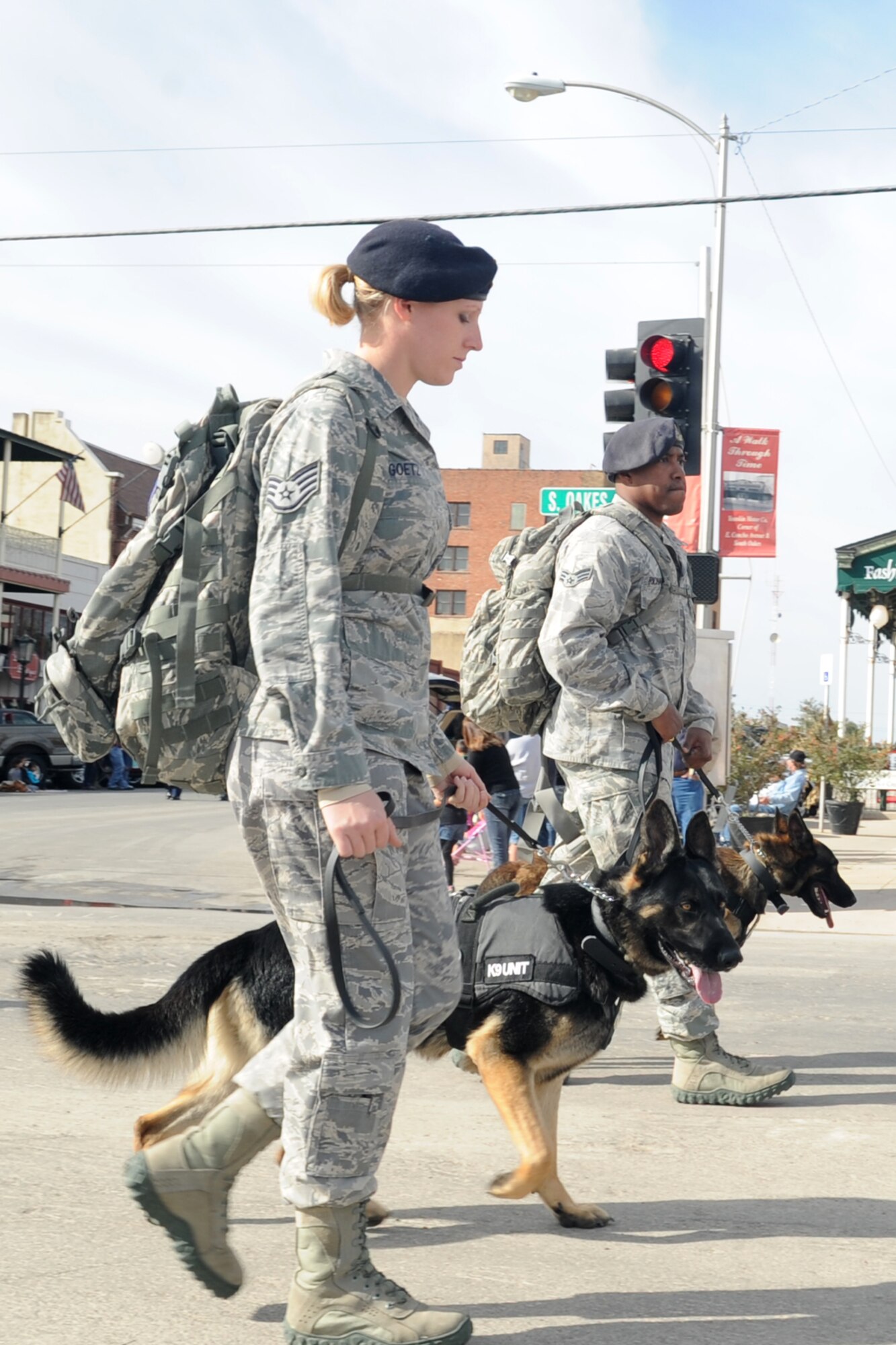 SAN ANGELO, Texas -- Staff Sgt. Amanda Goetz and Senior Airman Tyrell Richardson from the 17th Security Forces Squadron Military Working Dog Unit at Goodfellow Air Force Base, and their MWDs Jork and Hugo participate in the San Angelo Veterans Day Parade Nov. 5. (U.S. Air Force photo/Staff Sgt. Laura R. McFarlane)