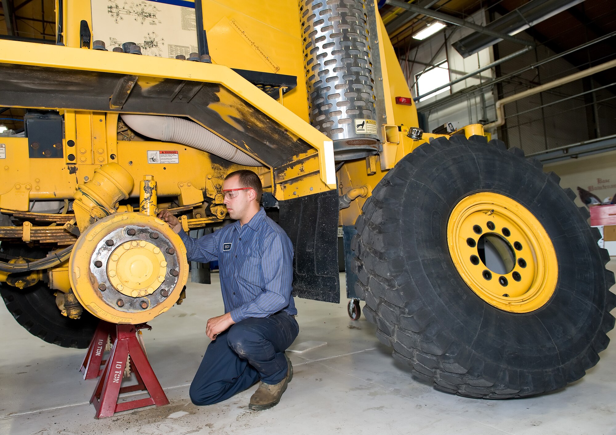 Airman James Beck, a vehicle maintenance apprentice with the 436th Logistics Readiness Squadron, works on the rear steering mechanism of a snow plow Nov. 3, 2011, at Dover Air Force Base, Del. The Multi-Purpose Vehicle Maintenance Section maintains and repairs all of the base’s snow removal vehicles. (U.S. Air Force photo by Roland Balik)