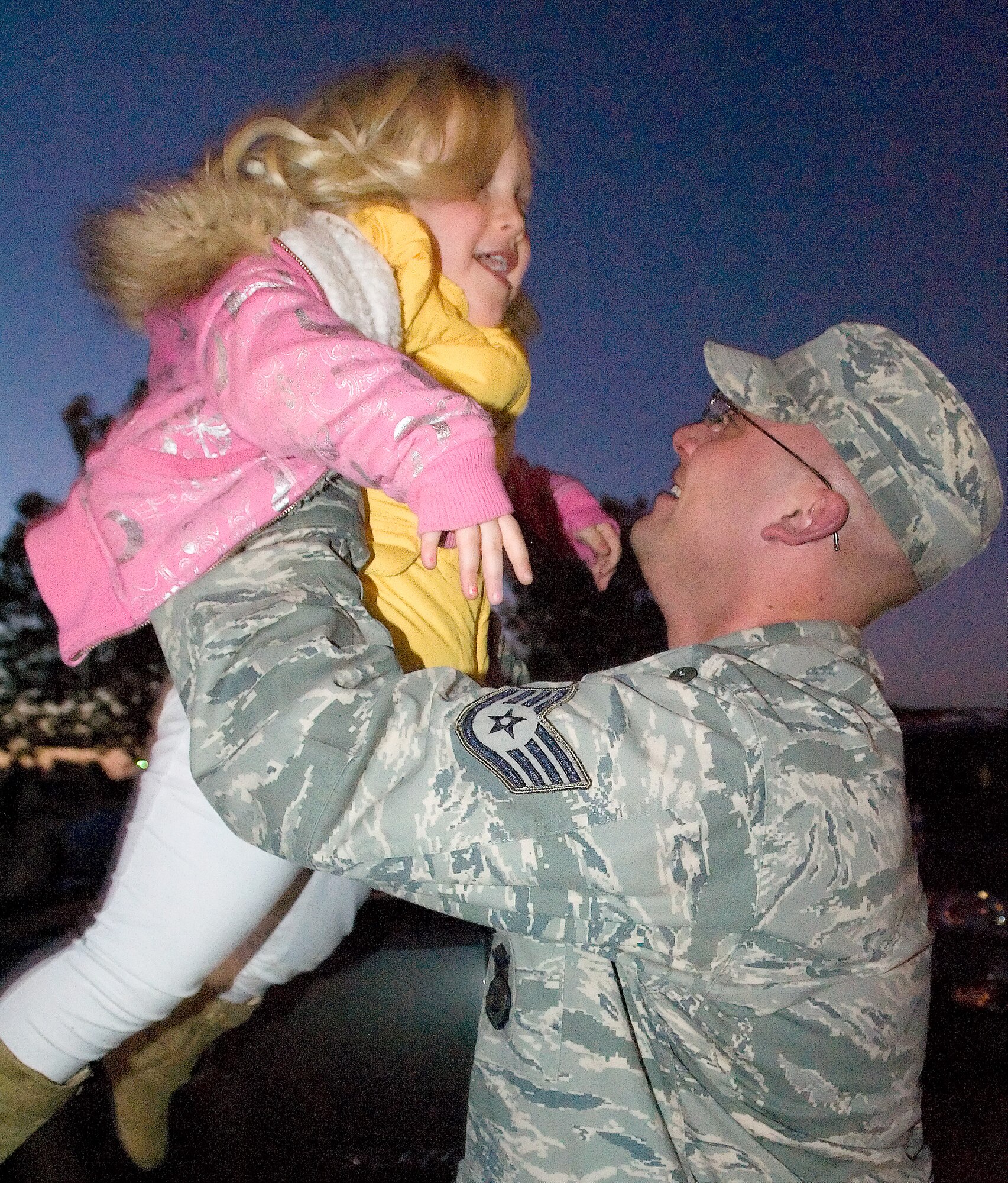 Staff Sgt. Michael Lawrence embraces his daughter, Liane, after returning Nov. 6, 2011, to Dover Air Force Base, Del. Lawrence was one of 13 members of the 436th Security Forces Squadron who returned from a 179-day deployment to Manas Transit Center, Kyrgyzstan. (U.S. Air Force photo by Airman 1st Class Samuel Taylor)   