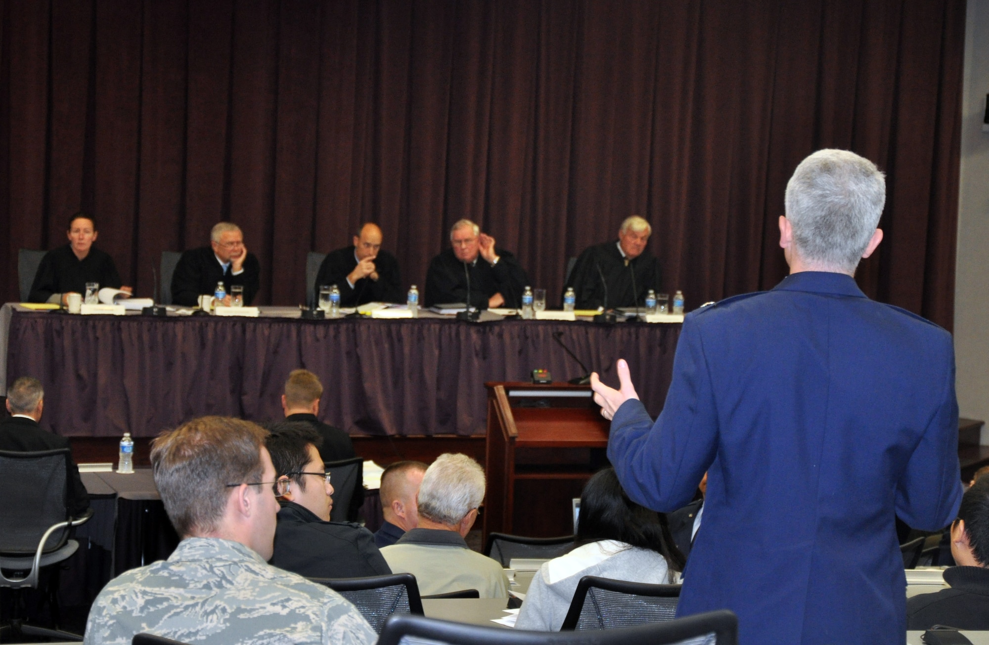 An audience member asks a question to one of the five judges from the U.S. Court of Appeals for the Armed Forces during a question and answer session in the Global Reach Planning Center on Nov. 3, 2011, at Scott Air Force Base, Ill. The U.S. Court of Appeals for the Armed Forces, as part of a "project outreach," held a hearing at Scott AFB on an actual case. After ajournment, they held a question and answer period for the audience of more than 100 people to learn more about the U.S. Court of Appeals for the Armed Forces. The court normally operates in Washington, D.C., and were hosted at Scott AFB by the Headquarters Air Mobility Command Judge Advocate office and the 375th Air Mobility Wing legal office. (U.S. Air Force Photo/Master Sgt. Scott T. Sturkol)