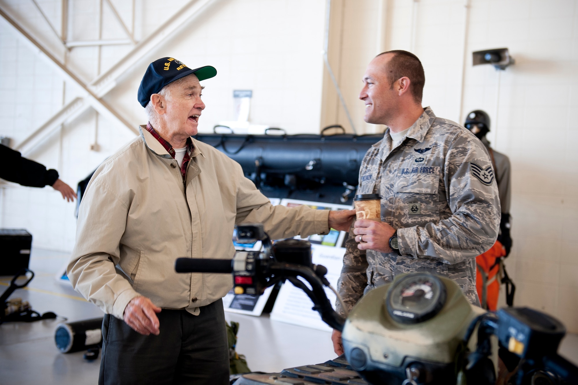 Retired U.S. Air Force Lt. Col. Paul Hutchins and Staff Sgt. Cody Whitaker, 38th Rescue Squadron pararescueman, share a laugh during Retiree Appreciation Day at Moody Air Force Base, Ga., Nov. 5, 2011. Hutchins served as an Air National Guard pilot for the 125th Fighter Group out of Jacksonville, Fla. (U.S. Air Force photo by Staff Sgt. Jamal D. Sutter/Released) 