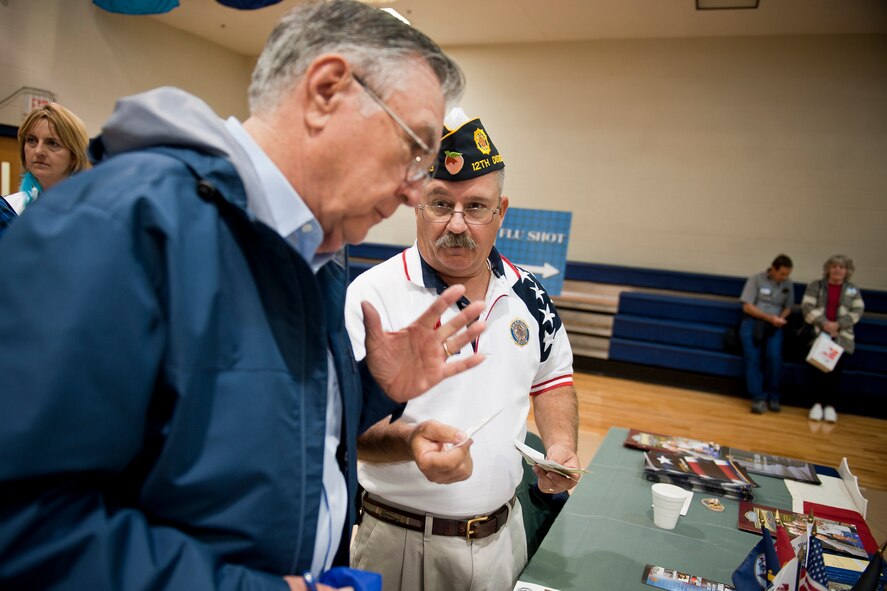 Retired U.S. Air Force Master Sgt. Ron Dixon speaks about American Legion membership with Bob Carpenter, American Legion 12th District of Georgia junior vice commander, during Retiree Appreciation Day at Moody Air Force Base, Ga., Nov. 5, 2011. As retirees and their families stopped by his booth, Carpenter provided information on what the VFW offers to the community and gave people the opportunity to join the organization. (U.S. Air Force photo by Staff Sgt. Jamal D. Sutter/Released) 