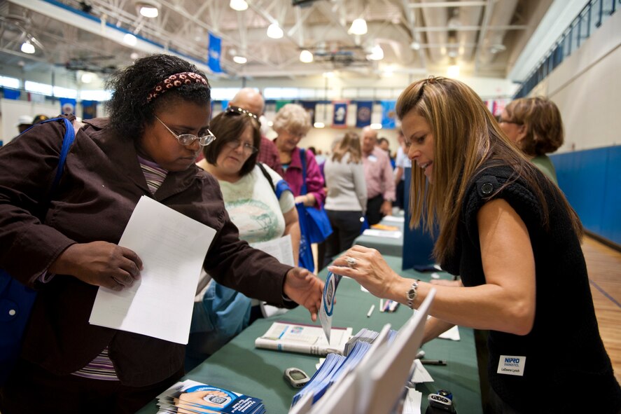 Sharon Taylor receives a product brochure from LaDawne Lynch during Retiree Appreciation Day at Moody Air Force Base, Ga., Nov. 5, 2011. Lynch represented a medical products company and provided information on diabetic meters and test strips. (U.S. Air Force photo by Staff Sgt. Jamal D. Sutter/Released)