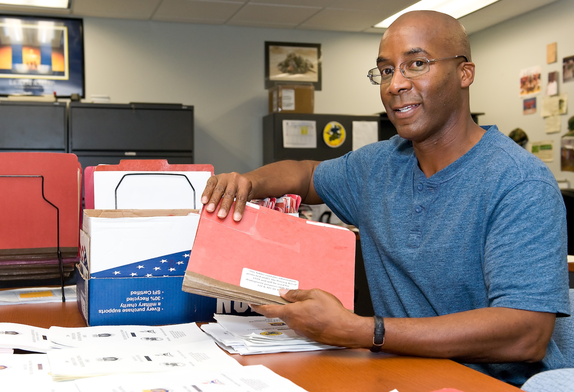 Nate Parker, the Unit Deployment Manager for the 436th Force Support Squardron, checks deployment folders for all 436 FSS Nov. 7, 2011, at Dover Air Force Base, Del. Parker was selected as Airman of the Week for the Nov. 11, 2011 edition of The Airlifter. (U.S. Air Force photo by Roland Balik)