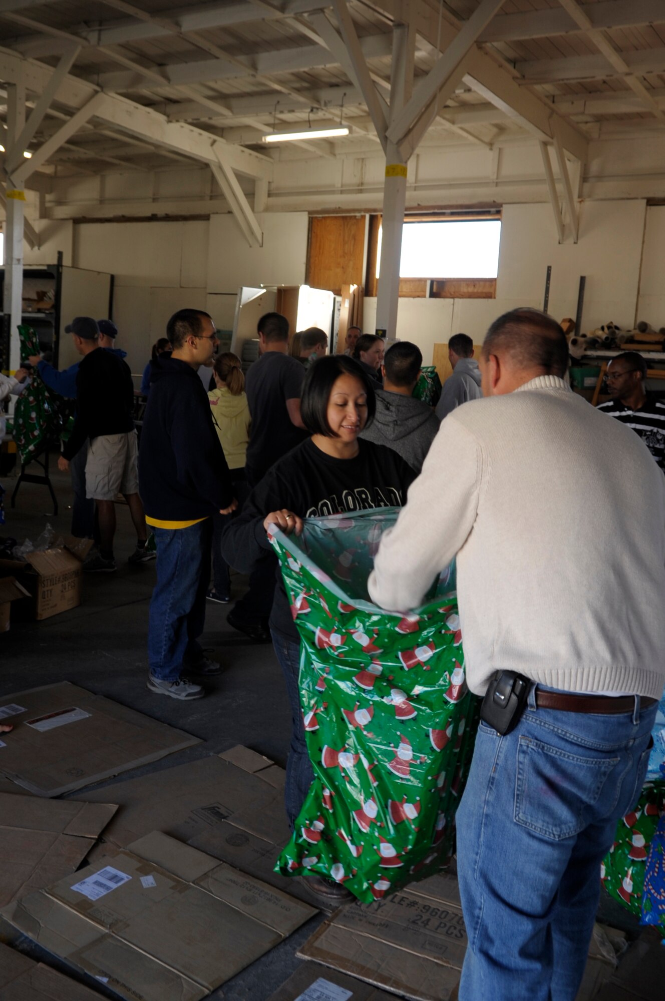 VANDENBERG AIR FORCE BASE, Calif. -- Operation Kids Christmas volunteers place gifts in bags here Saturday, Nov. 5, 2011. OKC is an annual event in which the men and women of Vandenberg sponsor approximately 200 local underprivileged children during the holidays. (U.S. Air Force photo/Jerry E. Clemens, Jr.)