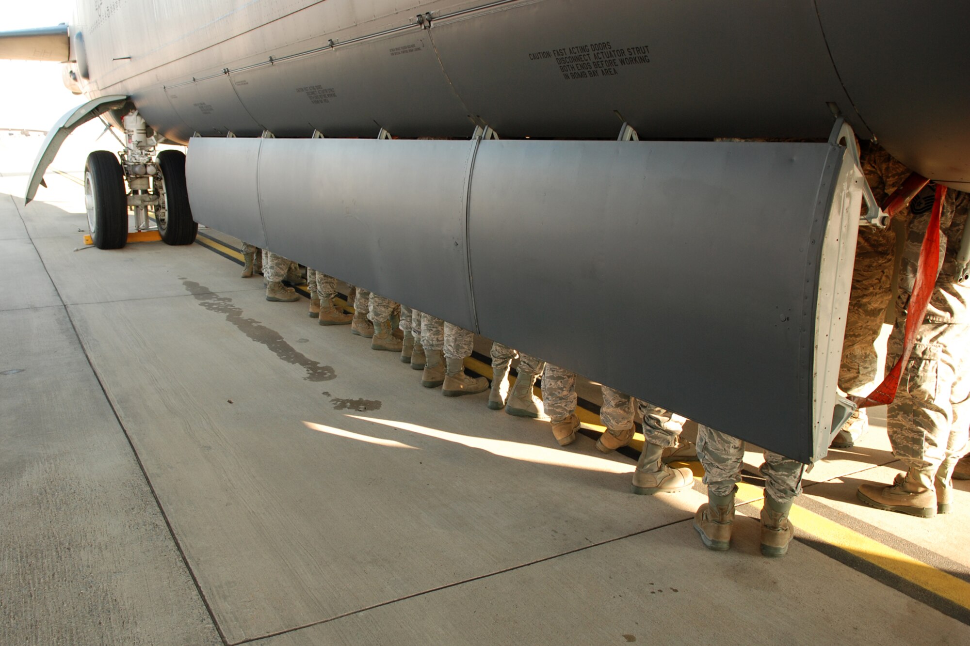 Boots of Airmen from the 307th Bomb Wing are all that can be seen as they stand in the bomb bay of a B-52 Stratofortress at Barksdale Air Force Base, La., Nov. 5, 2011.  The airmen toured the aircraft to gain a greater understanding of its mission and capabilities.  The tours are part of a wing initiative and occur at most unit training assemblies.  (U.S. Air Force photo by Staff Sgt. Theodore Daigle/Released)