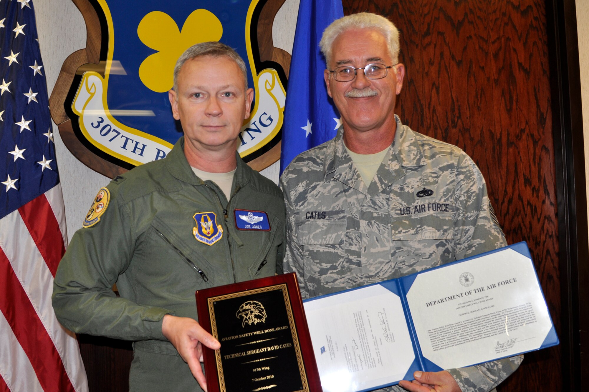 Tech. Sgt. David Cates, who is a B-52 aircraft mechanic assigned to the 307th Aircraft Maintenance Squadron, and Col. Joe Jones, the vice commander of the 307th Bomb Wing, pose for a photo after Cates was presented with an “Aviation Safety Well Done Award” at Barksdale Air Force Base, La., Nov. 5, 2011. (U.S. Air Force photo by Senior Master Sgt. Jessica D’Aurizio/Released)