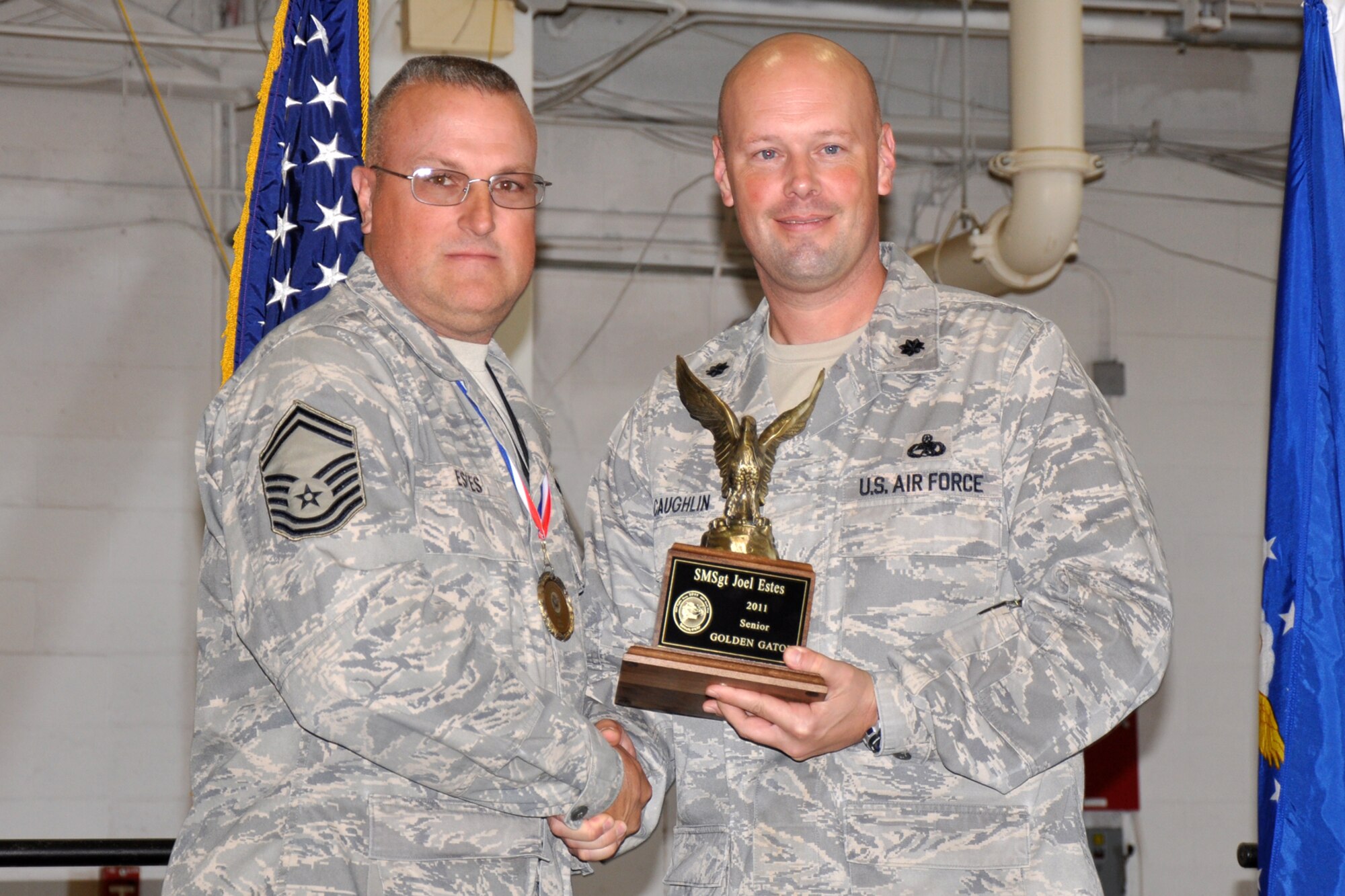 Senior Master Sgt. Joel Estes, who is assigned to the 917th Maintenance Squadron, and Lt. Col. Travis Caughlin, the deputy commander of maintenance for the 917th Fighter Group, pose for a photo after Estes was presented the “Senior Golden Gator Award” at the 12th Annual Gatorfest in the A-10 Hangar at Barksdale Air Force Base, La., Nov. 5, 2011. The individual in this category has been deemed to have made the greatest contribution within their career field to the 917th and 307th maintenance community. (U.S. Air Force photo by Master Sgt. Jeff Walston/Released)