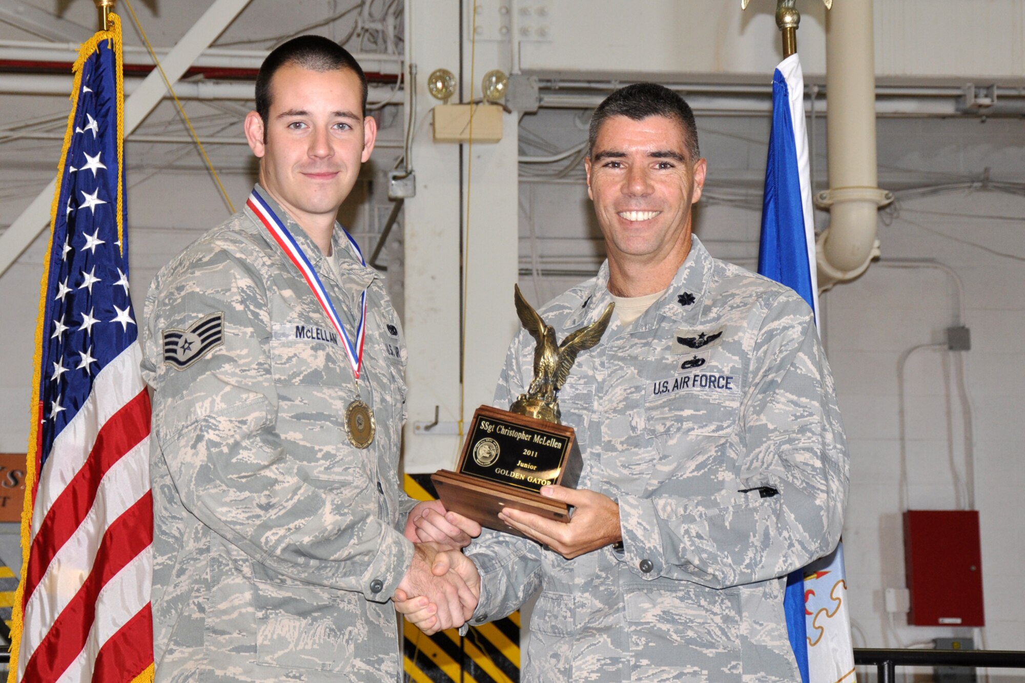 Staff Sgt. Christopher McLellen, who is assigned to the 2nd Aircraft Maintenance Squadron, and Lt. Col. Kenneth N. Rose, the commander of the 307th Maintenance Group pose for a photo after McLellen was presented the “Junior Golden Gator Award” at the 12th Annual Gatorfest in the A-10 Hangar at Barksdale Air Force Base, La., Nov. 5, 2011. The annual event serves to recognize maintenance Airmen for their accomplishments during the year in both the military and civilian worlds. (U.S. Air Force photo by Master Sgt. Jeff Walston/Released)