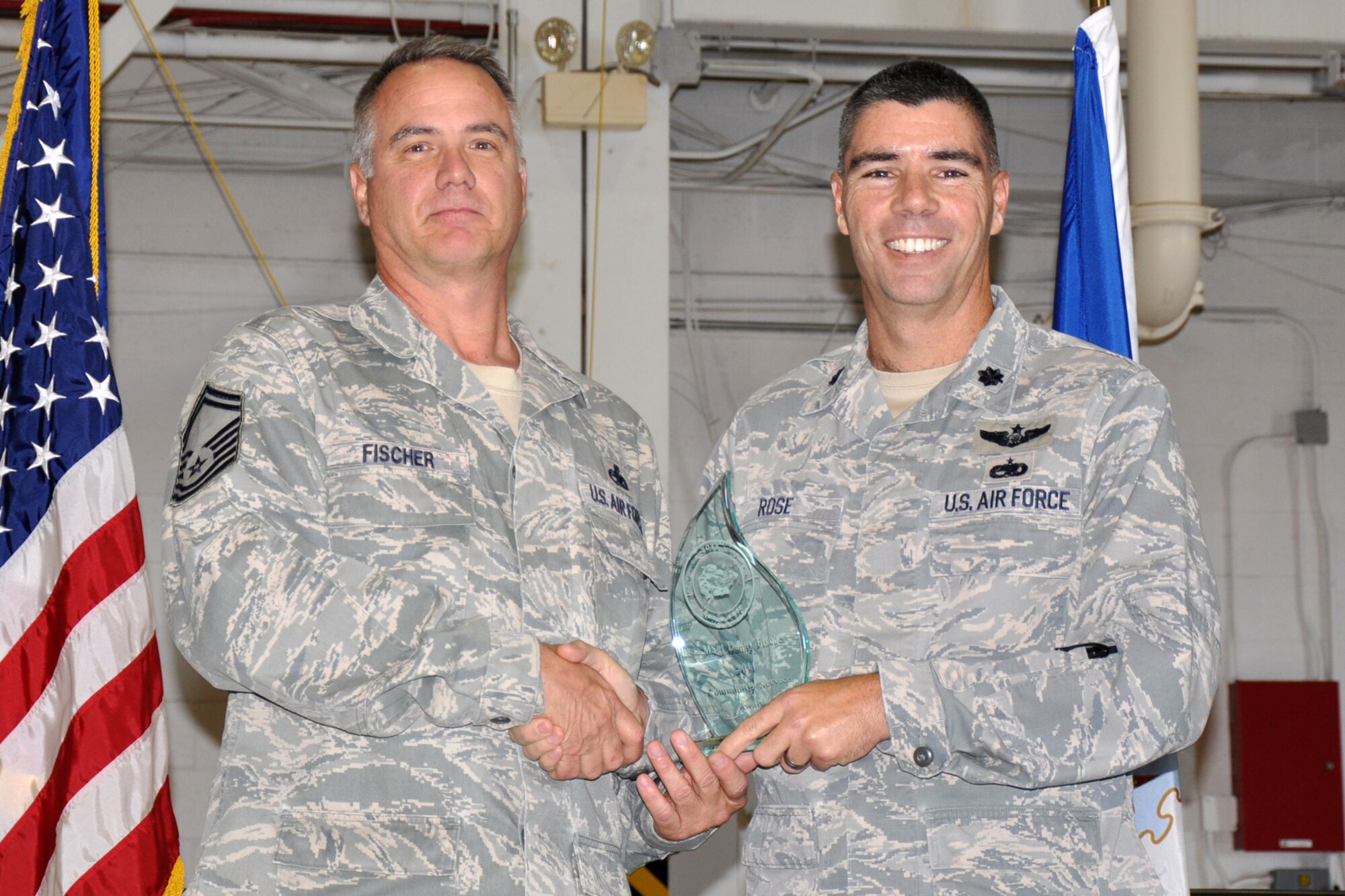 Senior Master Sgt. Danny Fischer, an aircraft armament systems mechanic assigned to the 307th Maintenance Squadron, and Lt. Col. Kenneth N. Rose, the commander of the 307th Maintenance Group pose for a photo after Fischer was presented the “Gatorfest Community Service Award” at the 12th Annual Gatorfest in the A-10 Hangar at Barksdale Air Force Base, La., Nov. 5, 2011. The annual event serves to recognize maintenance Airmen for their accomplishments during the year in both the military and civilian worlds. (U.S. Air Force photo by Master Sgt. Jeff Walston/Released)