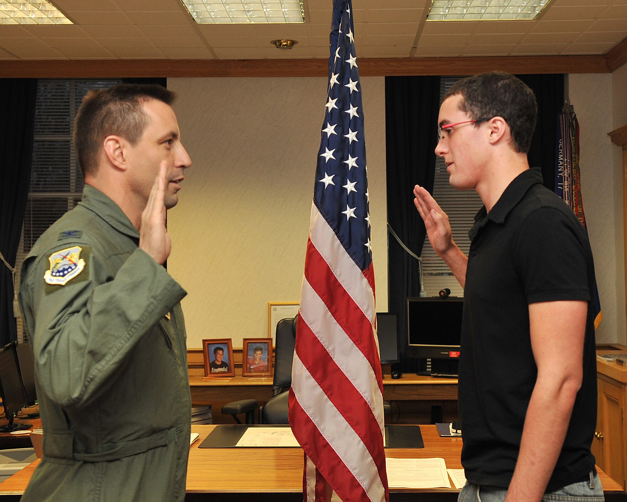 RAF MILDENHALL, England – Col. Christopher Kulas, 100th Air Refueling Wing commander, administers the oath of enlistment to Austin Powell, 18, here Nov. 3, 2011. Powell follows in his father’s footsteps in joining the U.S. Air Force. His father is the Chief Master Sgt. Christopher Powell, 100th ARW command chief master sergeant. Recruit Powell hopes to become a joint terminal attack controller. (U.S. Air Force photo/Senior Airman Jerilyn Quintanilla)