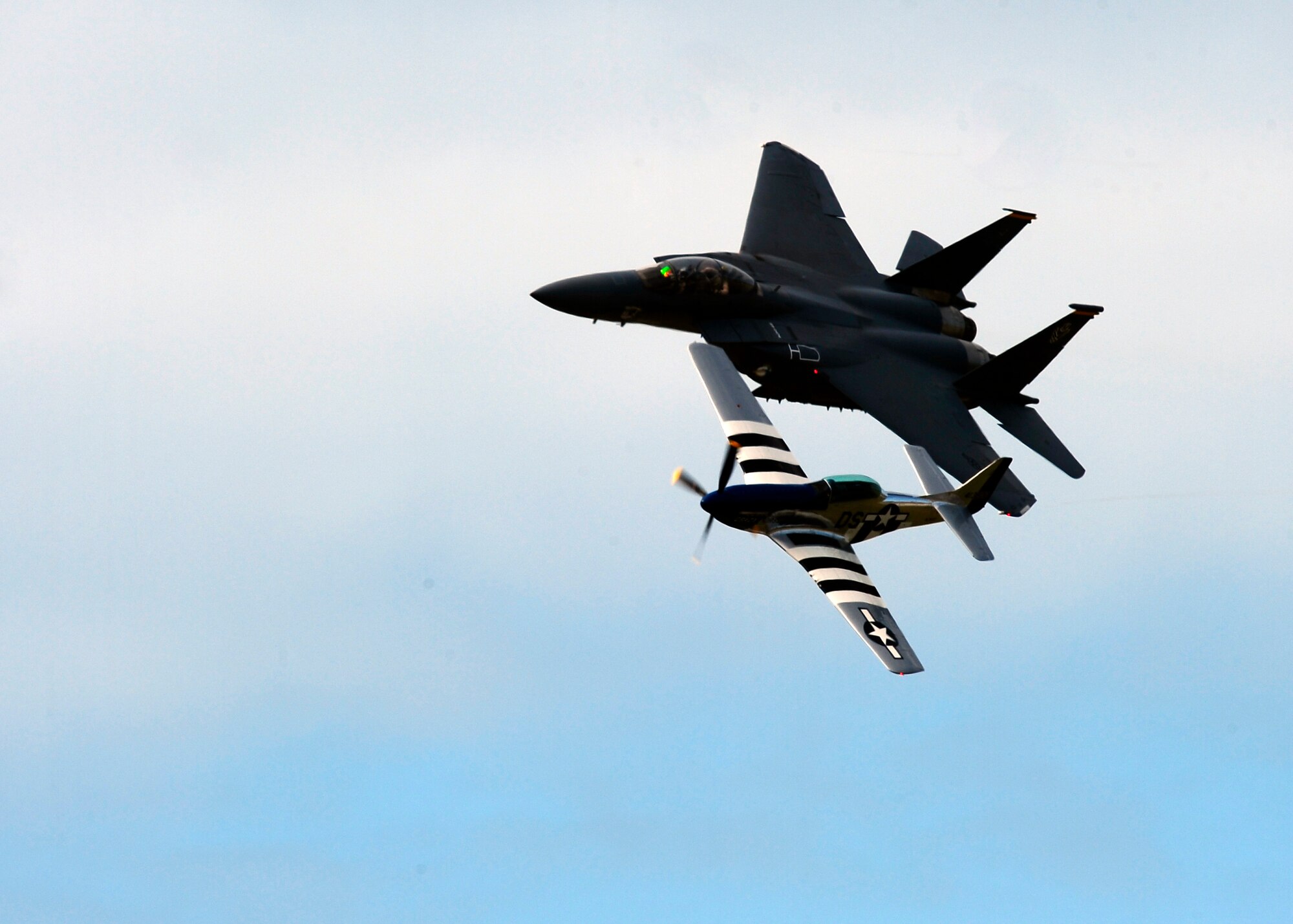 Maj. Michael Maeder, pilot of the F-15E Strike Eagle, and Lee Lauderback, pilot of the P-51 mustang “Crazy Horse,” fly alongside one another during the Heritage Flight at MacDill Air Force Base, Fla., AirFest, Nov. 6, 2011. AirFest offers the public an opportunity to meet the men and women of the armed forces and to see military equipment through the efforts of active duty guard and reserve service members, as well as civilian employees, retirees and family members. (U.S. Air Force photo by Airman 1st Class Melanie Bulow-Gonterman)   