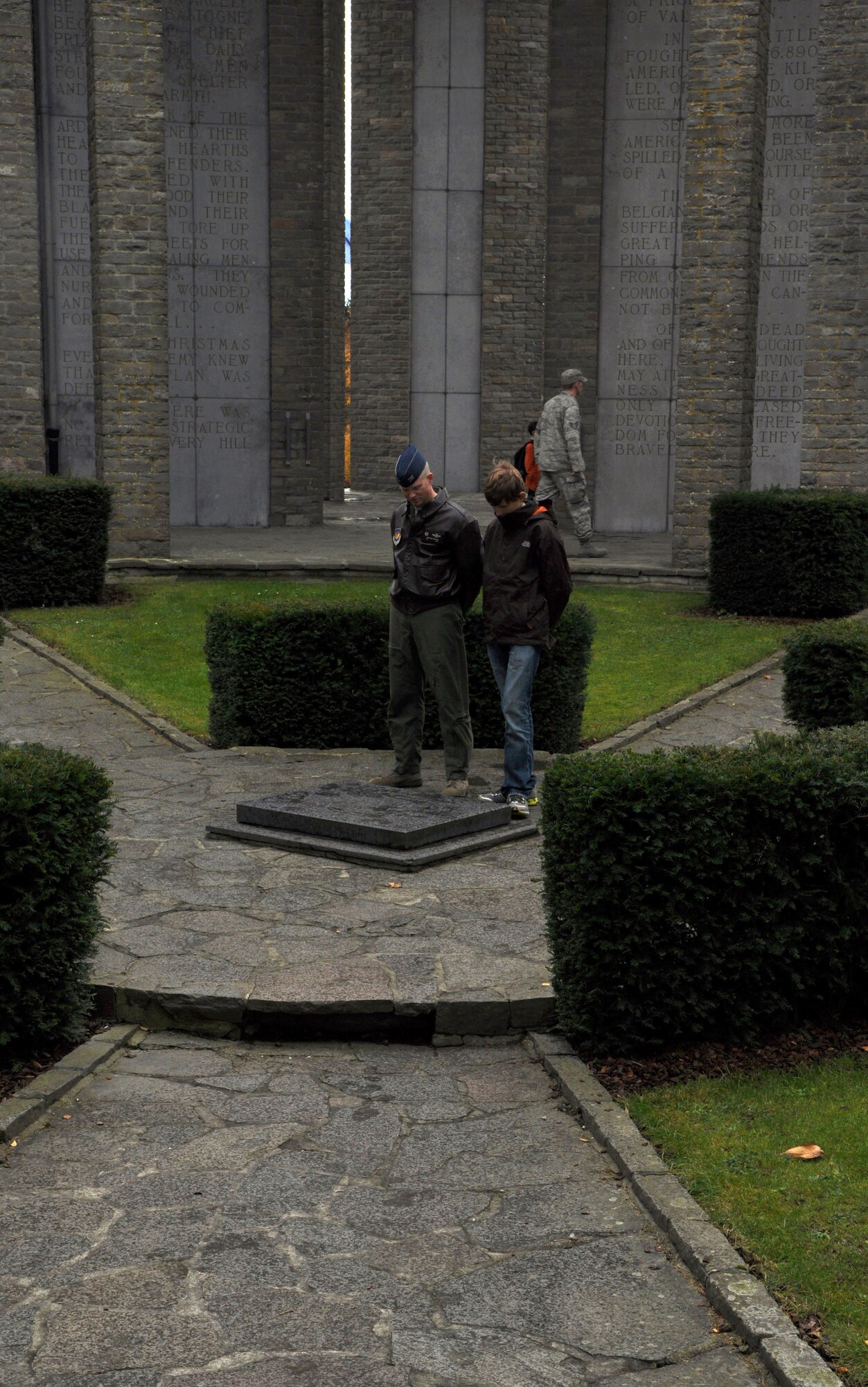 BASTOGNE, Belgium – Col. Chris Weggeman, 52nd Fighter Wing commander, and his son, Sam, view the memorial stone at the Mardrasson Memorial Nov. 4 here. The memorial is dedicated to the soldiers who fought in the Battle of the Bulge in Dec. 1944. Weggeman visited this memorial and other World War II sites with members of the 81st Fighter Squadron and their families as part of a squadron family day. (U.S. Air Force photo/Senior Airman Natasha Stannard)