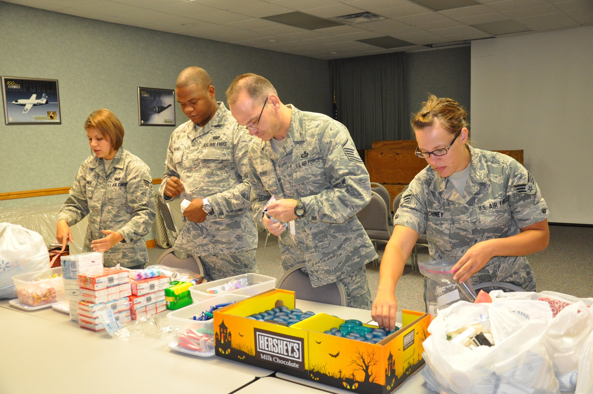 WRIGHT-PATTERSON AIR FORCE BASE, Ohio – From left to right, Senior Airman Laura Wagner, 445th Airlift Wing orderly room, Senior Airman Joshua Walker, 445th Airlift Wing orderly room, Master Sgt. Anthony Johns, 445th Operations Support Squadron first sergeant, and Senior Airman Chelsie Pechiney, 445th Airlift Wing orderly room, assemble donated items for local homeless veterans. The 445th Airman’s Council and 445th Spouses Council helped gather and assemble the donated items that totaled 100 bags. The items were distributed Oct. 21 during the VA Stand Down at the Dayton Veterans Affairs Medical Center in Dayton, Ohio. (U.S. Air Force photo/Stacy Vaughn)   