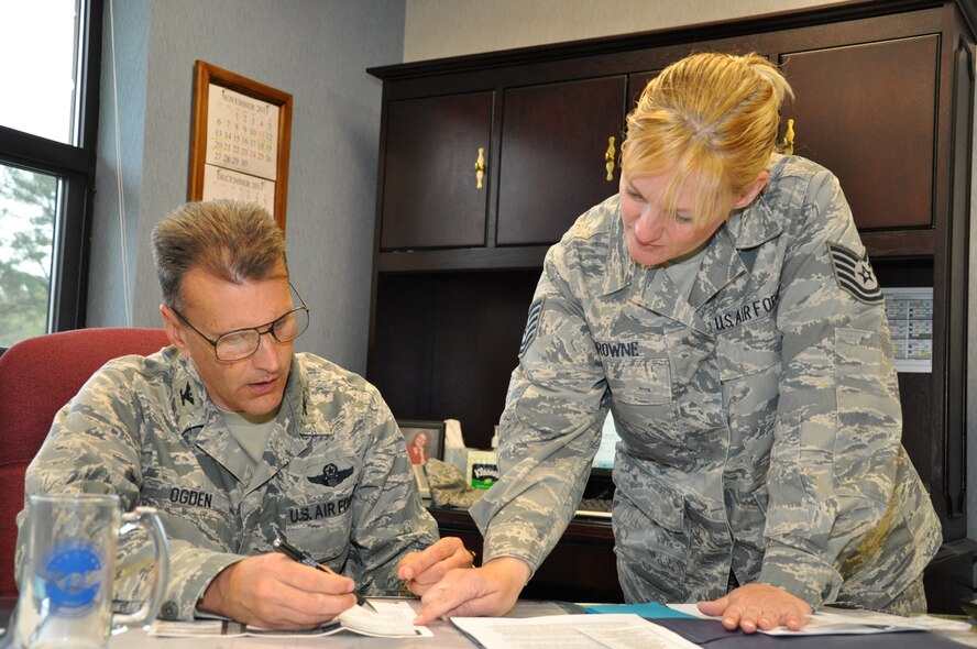 Tech. Sgt. Kimberly A. Browne, 916th Force Support Squadron, assists wing commander Col. Randall A. Ogden in filling out an application to become a lifetime member of the Air Force Sergeants Association on Nov. 4, 2011. Brown, who is the AFSA Division 3 Membership Co-Chair, recruited Ogden as part of the local chapter's effort to grow to at least 1100 members by the end of the year. (USAF photo by MSgt. Wendy Lopedote, 916ARW/PA)