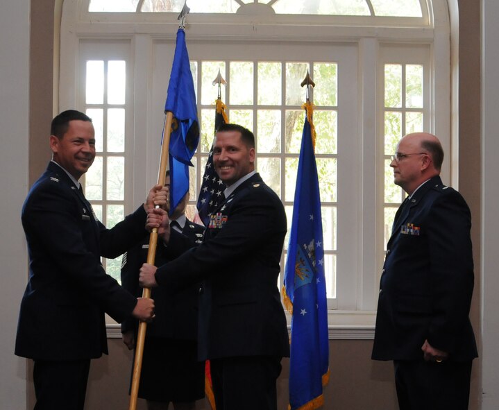 Maj. Dustin Pawlak (center) receives command of the 916th Force Support Squadron from Col. James Hurley (left) on Oct. 22, 2011. Lt. Col. Keith Howell (right) relinquished command of the squadron. (USAF photo by Tech. Sgt. Scotty Sweatt, 916ARW/PA)