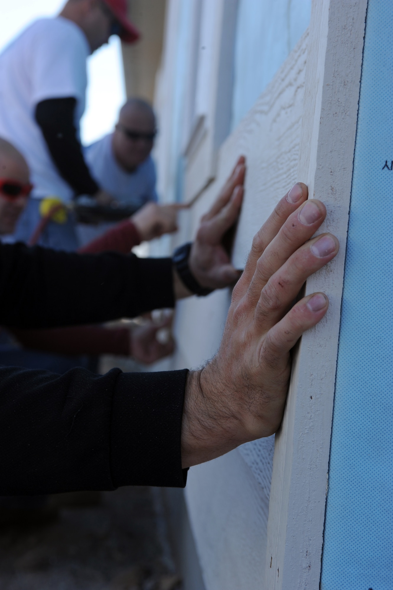 JOPLIN, Mo.--Master Sgt. Keith Lockard nails on siding to the house Nov. 1, 2011. Efforts were made to re-build 10 houses for families that lost their homes during the May 22 Joplin Tornado. Lockard is assigned to the 509th Civil Engineer Squadron at Whiteman Air Force Base. (U.S. Air Force photo/Senior Airman Laura Goodgame)