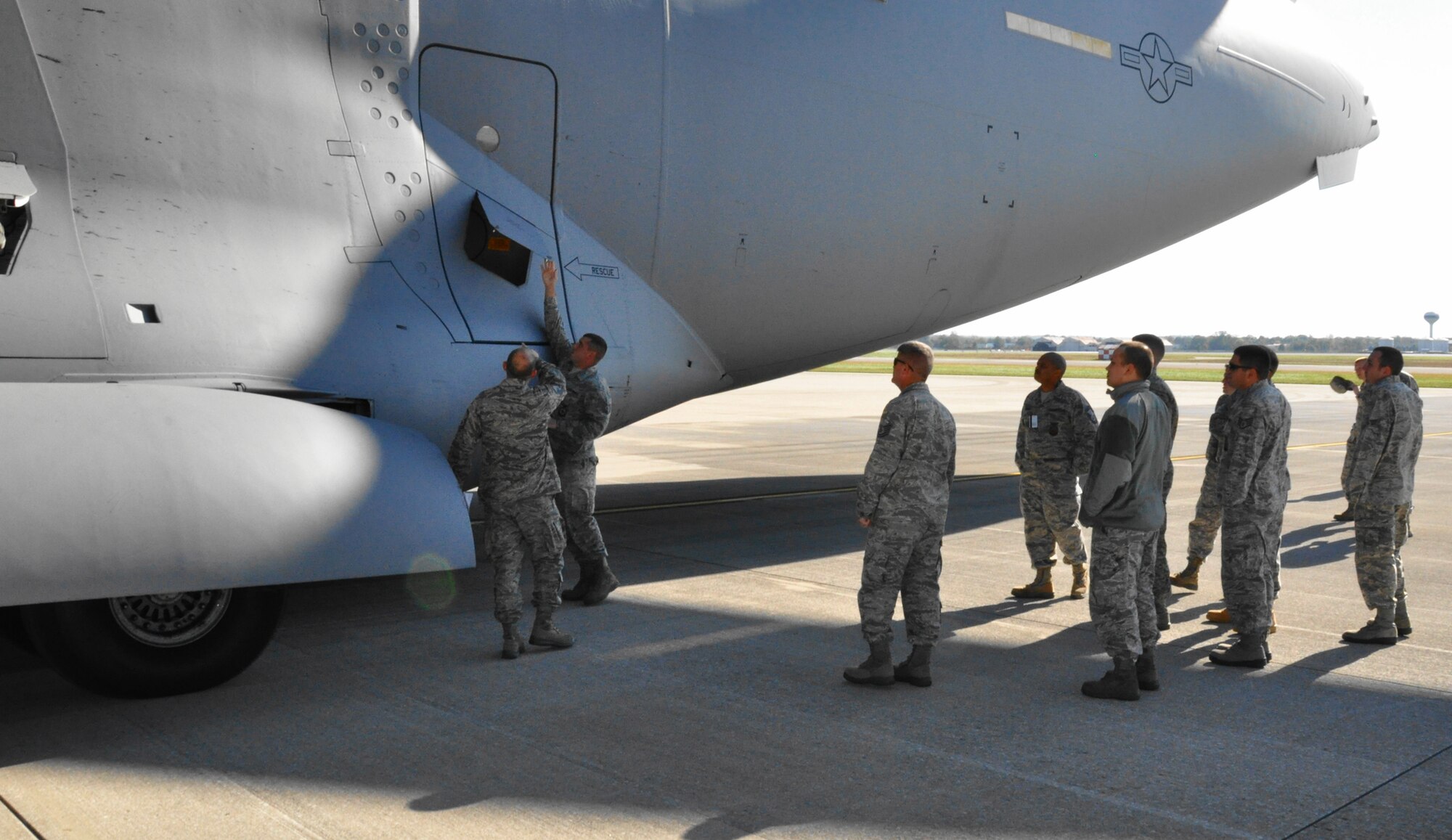 WRIGHT-PATTERSON AIR FORCE BASE, Ohio - Master Sgt. Kenneth Finch, an instructor with the 445th Civil Engineer Squadron, explains an exterior electrical outlet on the fuselage of a C-17 Globemaster III to a group of 445th firefighters. (U.S. Air Force photo/Master Sgt. Charlie Miller)