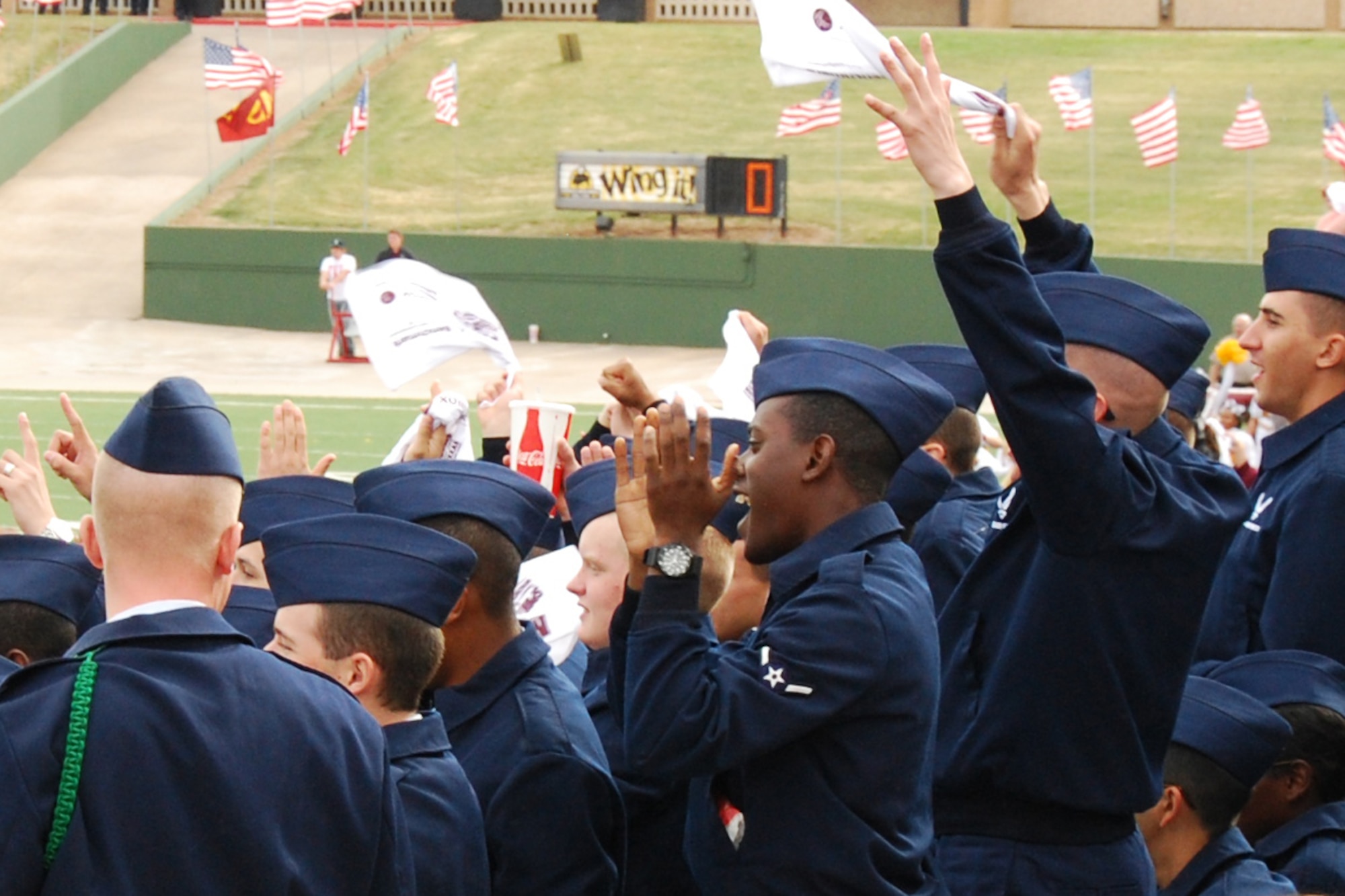 Sheppard Airmen cheer during the Midwestern State University military appreciation game against West Texas A&M University at Memorial Stadium, Wichita Falls, Texas, Nov. 5, 2011. Saturday’s game included a T-6 Texan II flyover by the 80th Flying Training Wing, a presentation to Sheppard and Fort Sill commanders, and the inclusion of a formation of Airmen and Soldiers in the half time show. (U.S. Air Force photo/Capt. Brittany Martin)