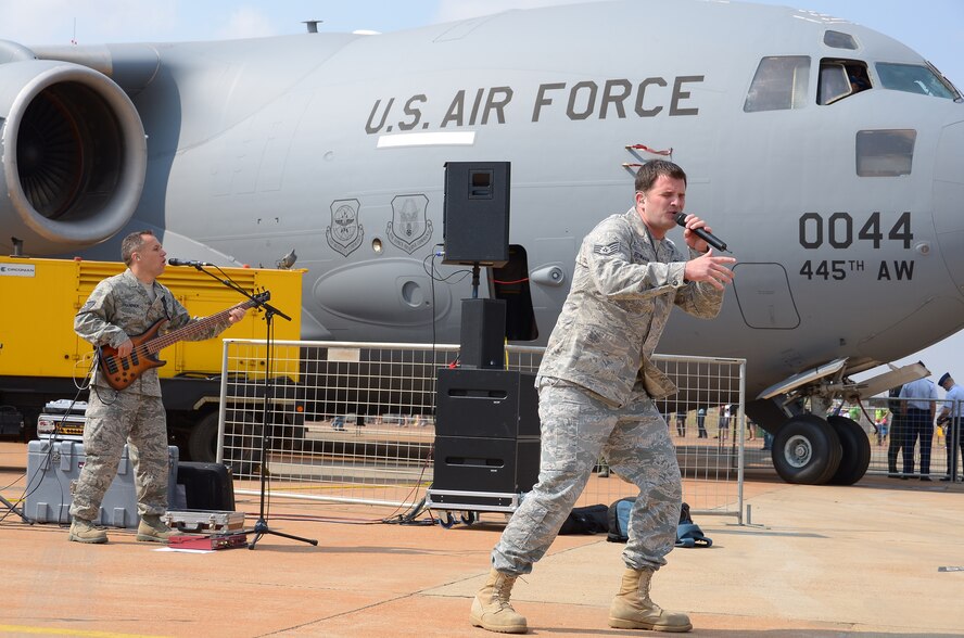 WRIGHT-PATTERSON AIR FORCE BASE, Ohio - Staff Sgt. Craig Bowman, vocalist with Touch 'n Go, a music ensemble of the U.S. Air Forces in Europe Band, performs in front of a 445th Airlift Wing C-17 Globemaster III during the South African Air Show Oct. 1. (U.S. Air Force photo/Senior Airman Mikhail Berlin)