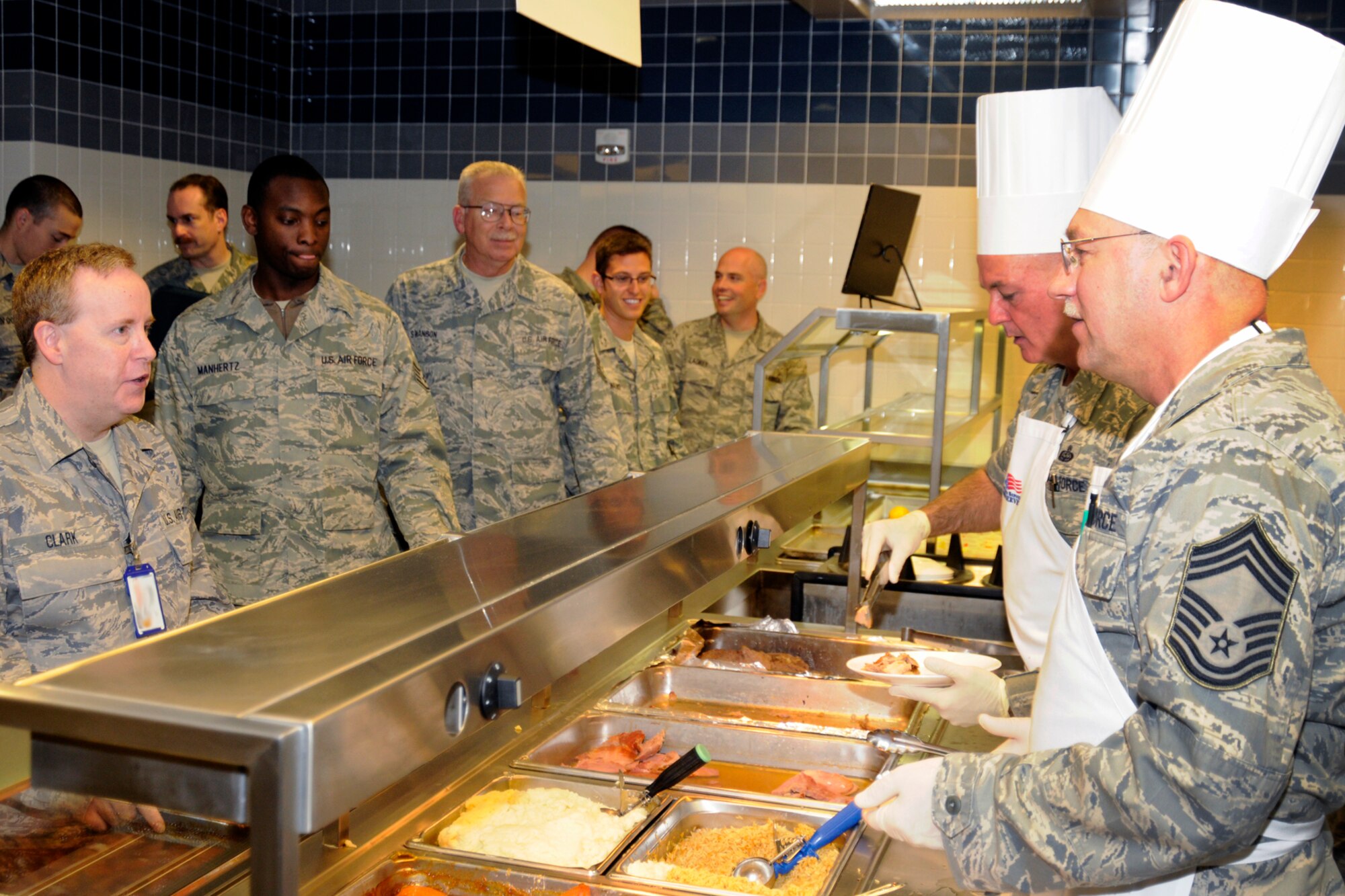 CMSgt. Tim Daniels, right, and CMSgt. Allyn Finkbeiner work to serve up a holiday meal for the Airmen of the 127th Wing, Michigan Air National Guard, at the dining facility at Selfridge Air National Guard Base, Mich., Nov. 5, 2011. The chief master sergeants of the 127th Wing typically serve lunch during the Saturday of the November drill weekend to mark Thanksgiving. Chief master sergeants are the senior enlisted members of the U.S. Air Force and play a key role in leading and shaping the Air Force. (U.S. Air Force photo by TSgt. David Kujawa)