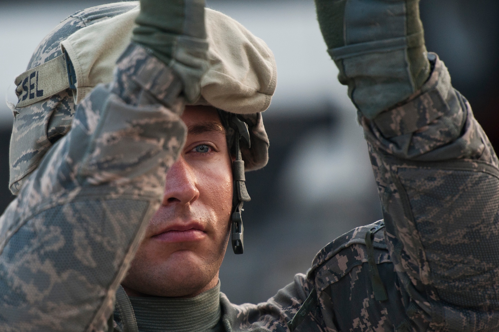 U.S. Air Force Senior Airman, Ryan Baker, a native of Fishers, IN., looks through his bloodshot eyes while loading a mine-resistant ambush protected on a trailer at Forward Operating Base Warrior on Oct. 27, 2011.  After driving 150 miles at night in a 43 vehicle convoy through Iraq, Airmen from the 70th MDS have to complete loading their trucks before getting to sleep. (U.S. Air Force Photo/Master Sgt. Jeffrey Allen)