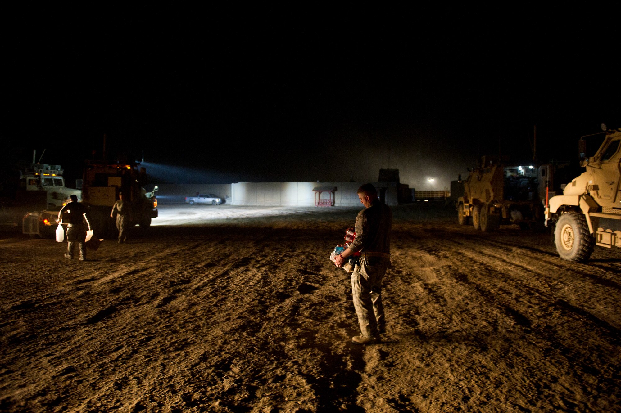 U.S. Air Force Staff Sgt. Joseph Worrell, 70th medium truck detachment, carries "class-1" (sports drinks) to his truck before beginning the third leg of a seven day convoy on Oct. 26, 2011. The truckers typically load coolers in their trucks with sports drinks, energy drinks and sweet snacks to help keep them awake while traveling all night. The team is taking 43 vehicles and 60 passengers more than 1,100 miles through Iraq to transport equipment and supplies out of the country in order to meet the military transition deadline. (U.S. Air Force Photo/Master Sgt. Jeffrey Allen)