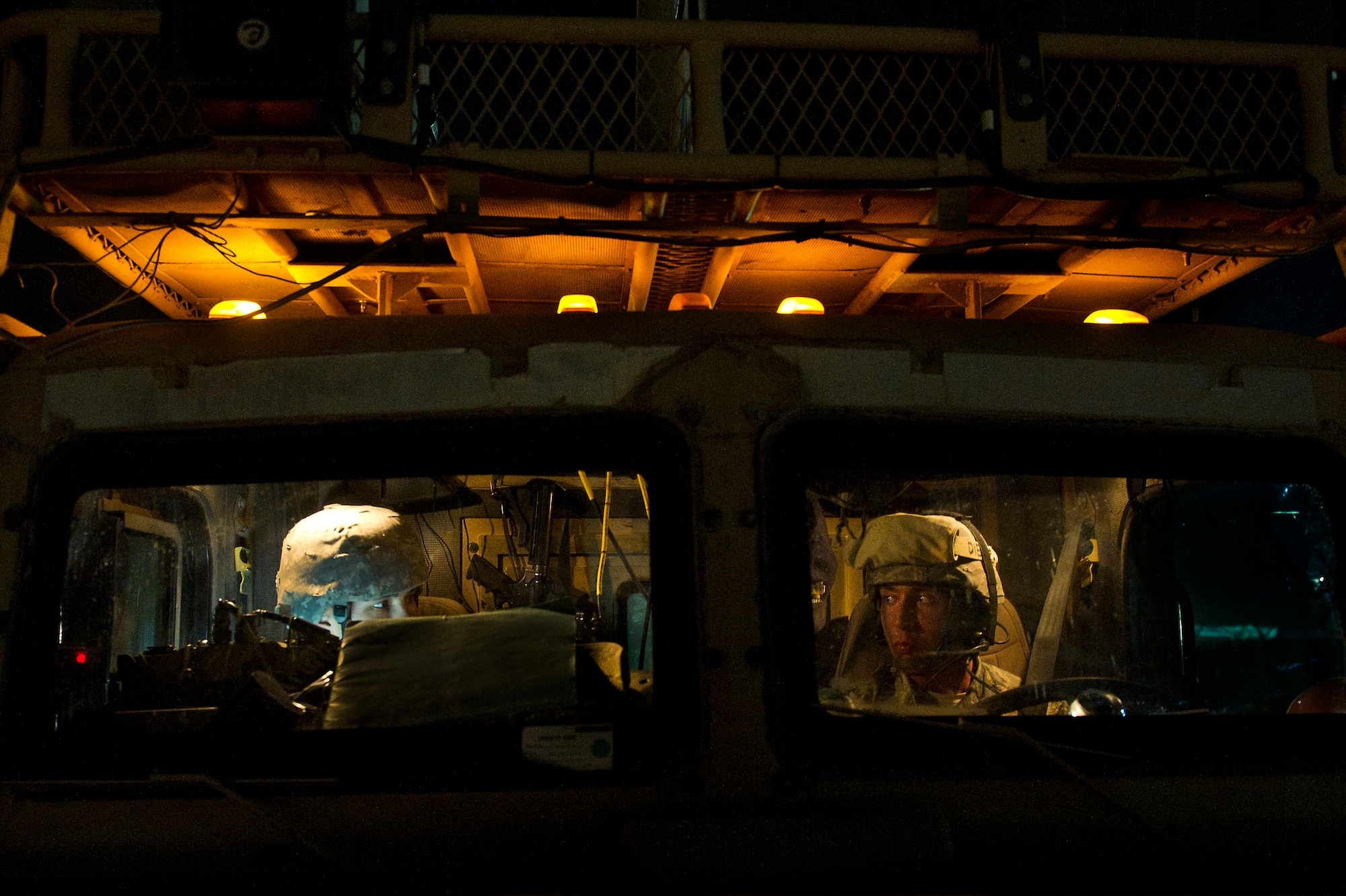 U.S. Air Force Tech. Sgt. David Perez (left), convoy commander, 70th medium truck detachment and Santa Fe, NM. native, talks to his driver, Senior Airman, Ryan Baker, from Fishers, IN., before leaving on the second leg of a seven day convoy through Iraq on Oct. 23, 2011. Perez is deployed from KIrtland AFB, NM and Baker is deployed from Hurlburt Field, Fla. Perez is responsible for leading a convoy of 43 vehicles and 60 passengers more than 1,100 miles through Iraq. Members of the 70th MTD are hauling equipment out of Iraq to meet the deadline for the U.S. military transition from Iraq. (U.S. Air Force Photo/Master Sgt. Jeffrey Allen)
