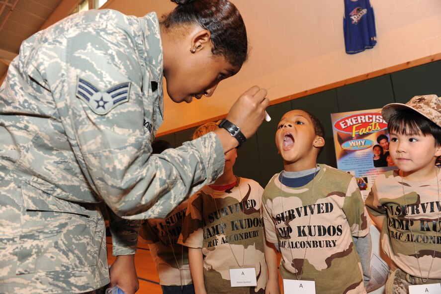 RAF ALCONBURY, United Kingdom - Senior Airman Jaresa Ross, 423rd Medical Squadron, participates in Camp Kudos. Children went through a mock deployment line and then to a deployed Base "X" to better understand what goes on during a deployment. (U.S. Air Force photo by Senior Airman Joel Mease)