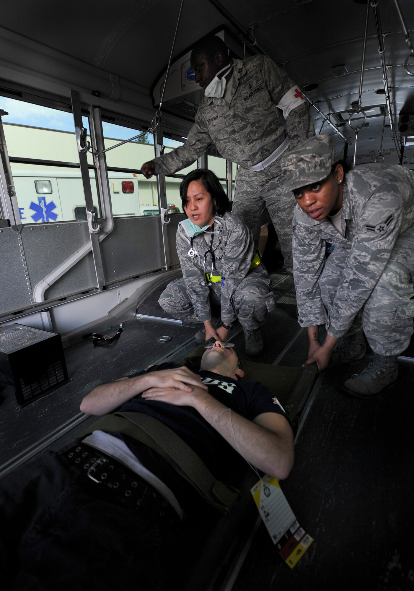 YOKOTA AIR BASE, Japan -- Airmen from the 374th Medical Operations Squadron load a wounded victim on a bus to transport to the hospital during an operational readiness exercise at Yokota Air Base, Japan, Nov. 7, 2011. The ORE tests Airmen's knowledge and ability in a variety of areas in both the peacetime and wartime mission. (U.S. Air Force photo/Staff Sgt. Stacy Moless)